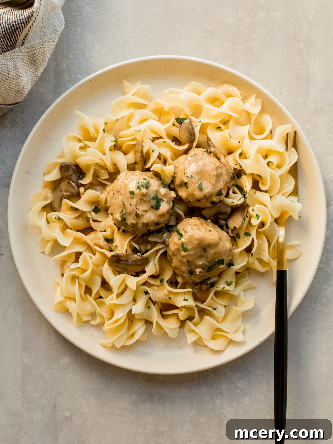 Creamy Chicken Meatball Stroganoff 8 chicken meatballs with mushroom sauce served over cooked egg noodles.