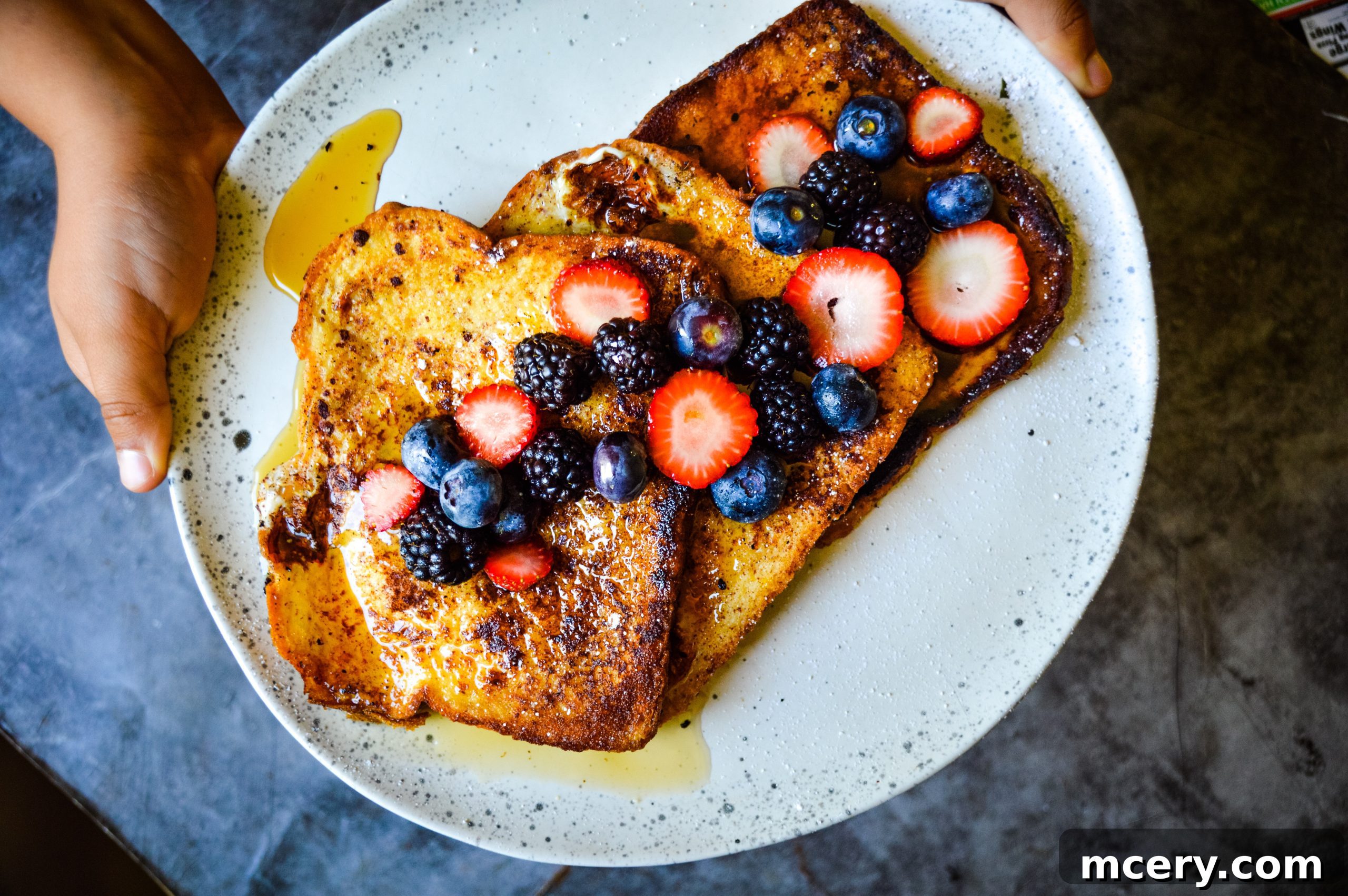 A close-up shot of golden-brown French Toast, perfectly cooked and ready to be garnished.