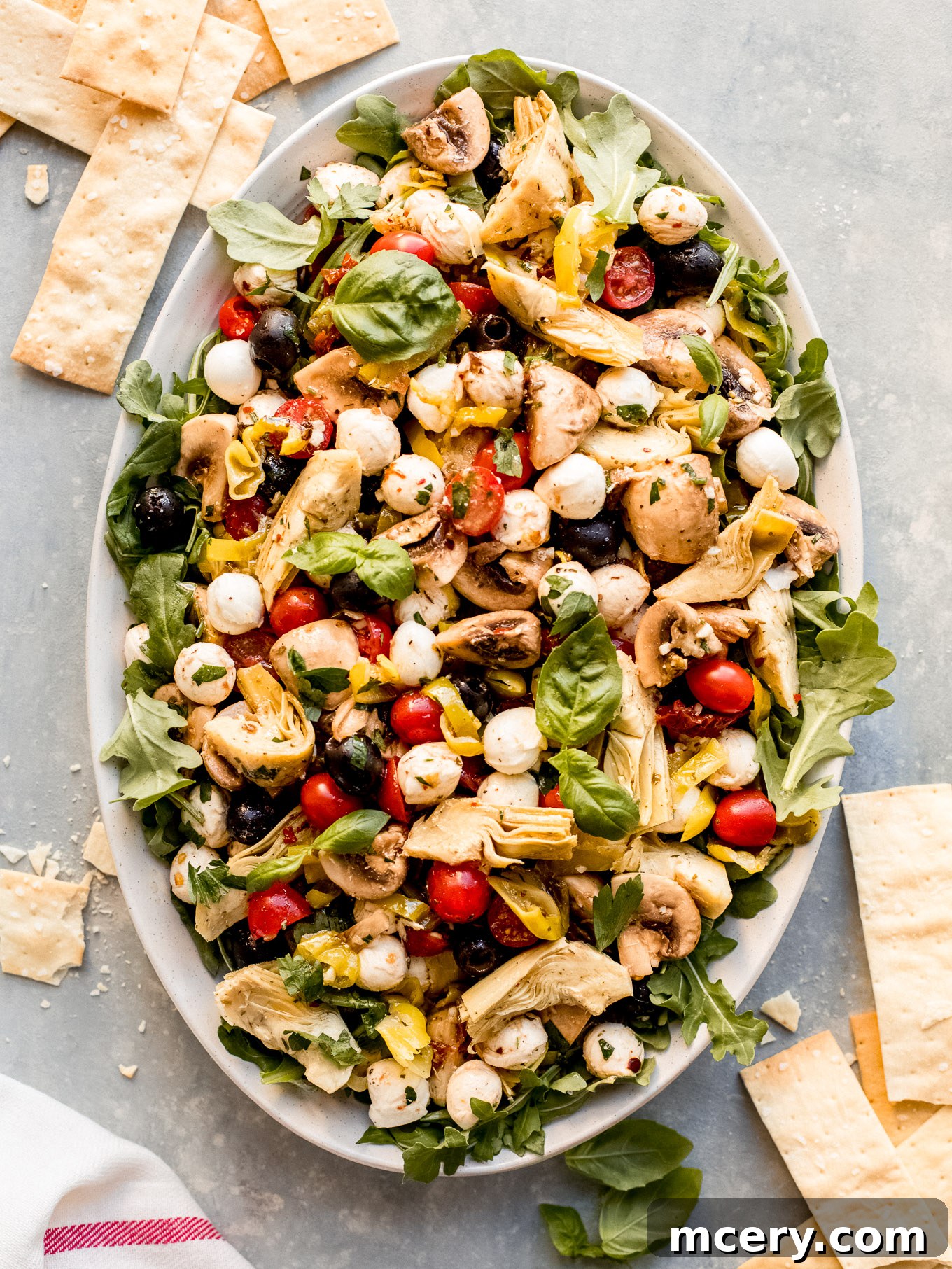 A beautifully arranged deconstructed antipasto salad platter, vibrant and inviting.