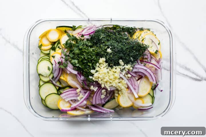 Thinly sliced squash and onions in a bowl