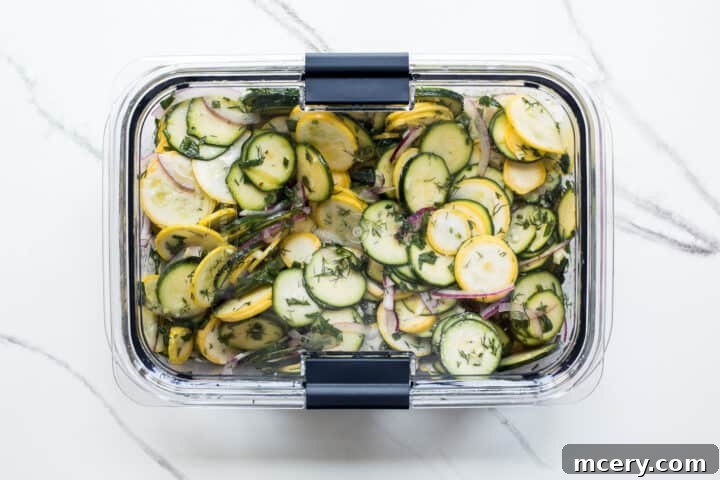 Marinated squash salad resting in a tupperware container