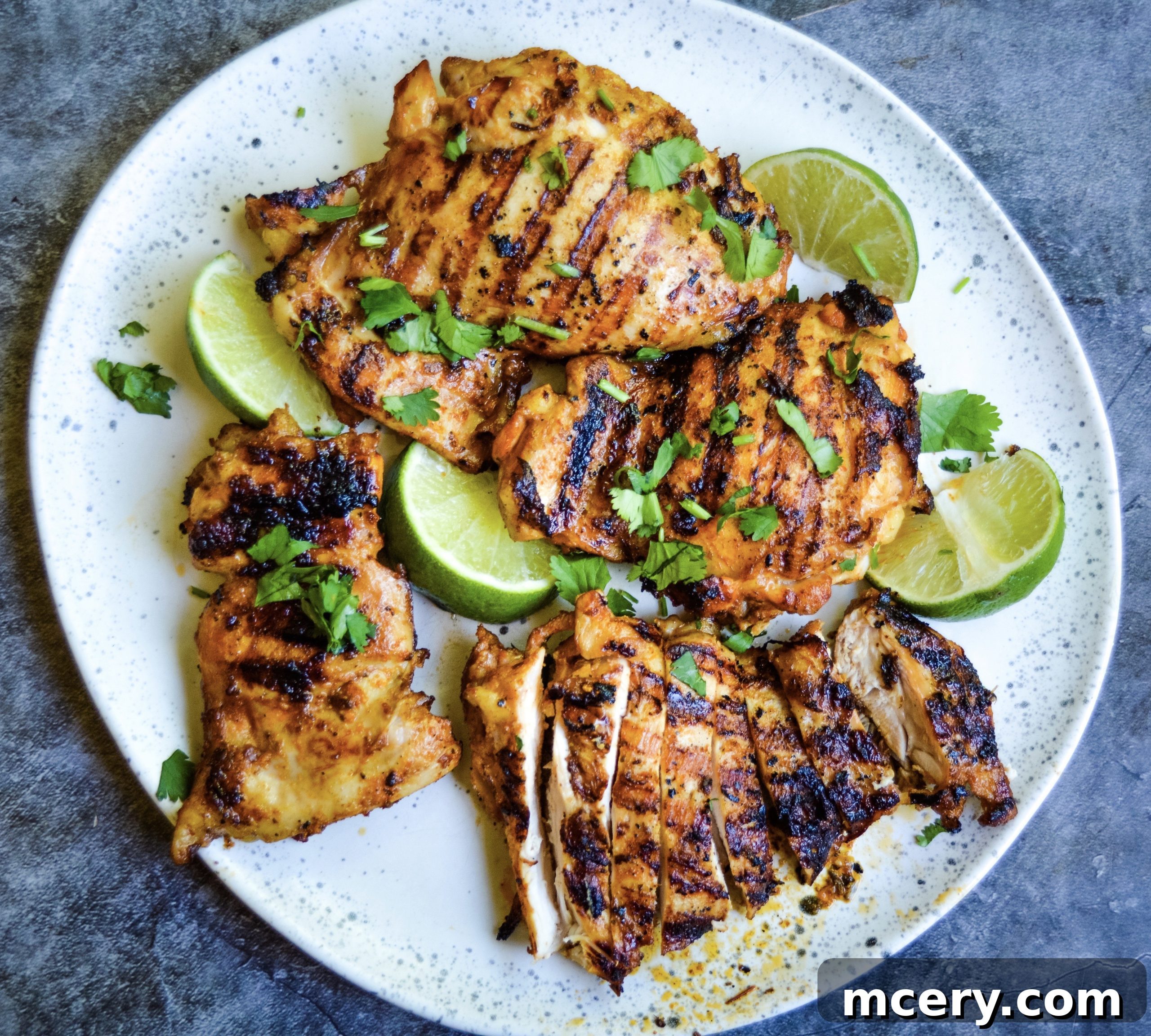 Delicious grilled Orange Chipotle Chicken served with fresh lime and cilantro.
