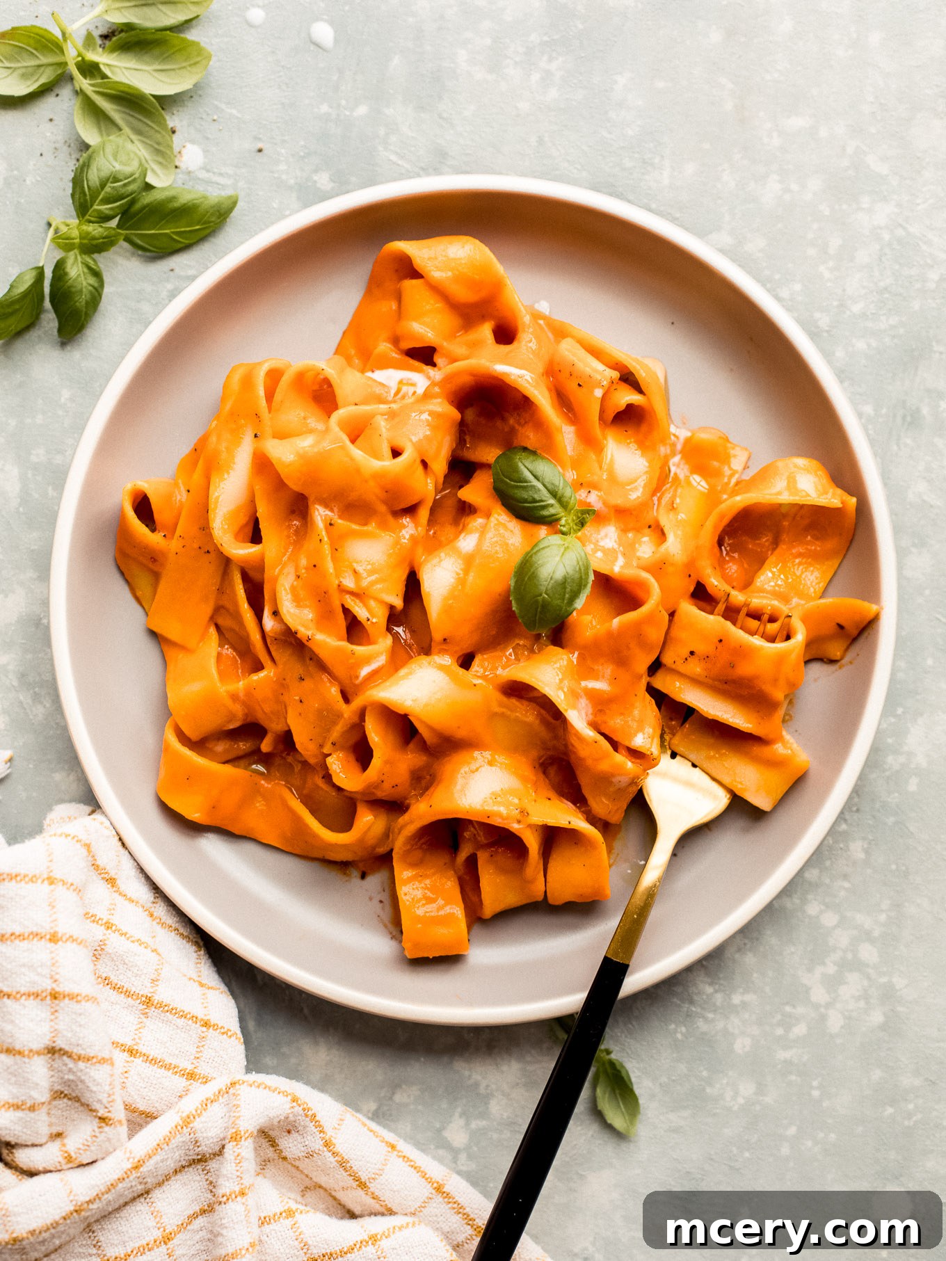 vegan vodka sauce recipe tossed with pasta and plated.