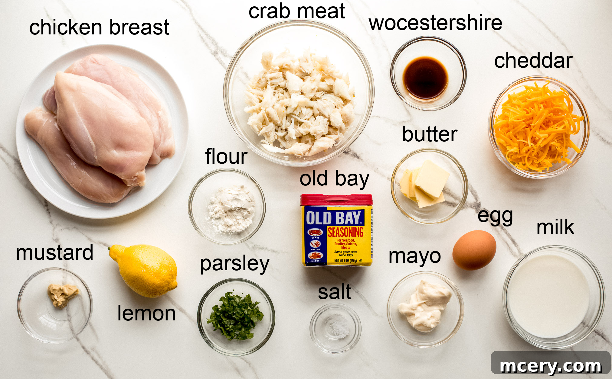 Gourmet Chesapeake Chicken 4 Fresh ingredients laid out for preparing Chicken Chesapeake, including chicken breasts, crab meat, cheese, and seasonings.