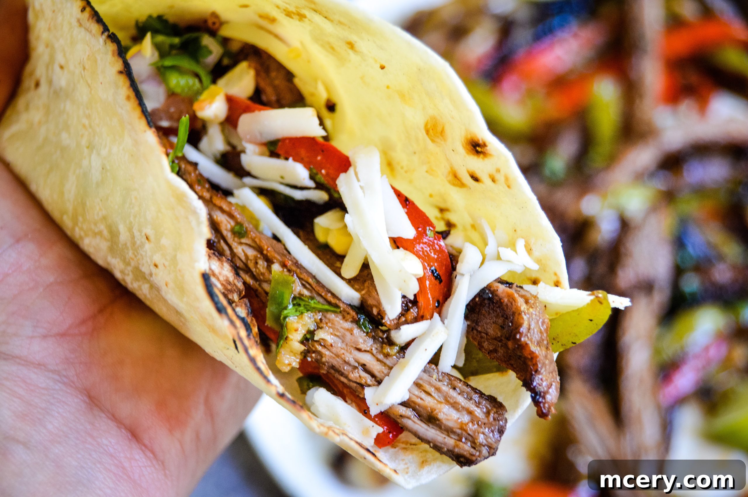 A spread of fajita toppings including salsa, guacamole, and warm tortillas.