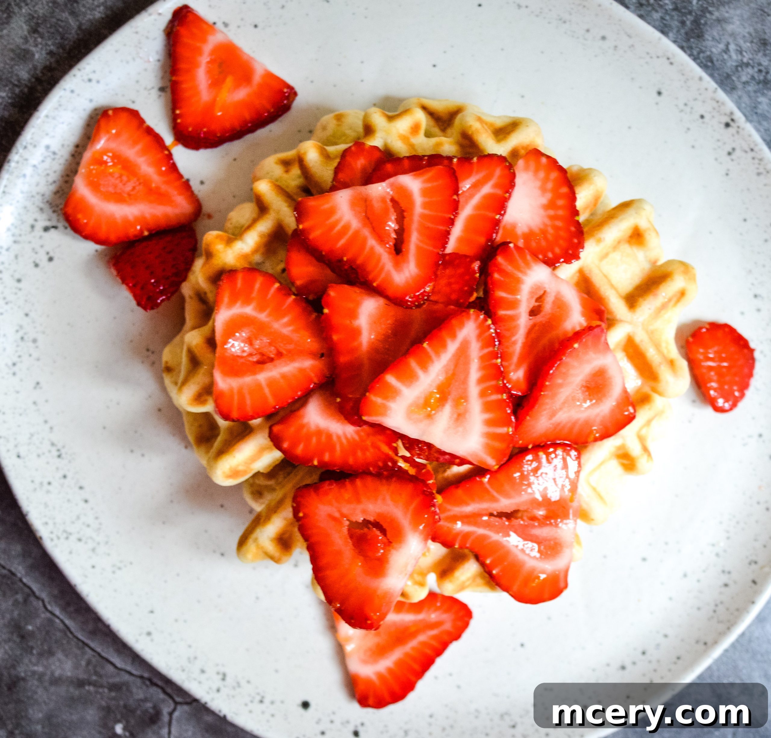 Ingredients for healthy waffles laid out on a kitchen counter: flour, oats, eggs, milk, and coconut oil.