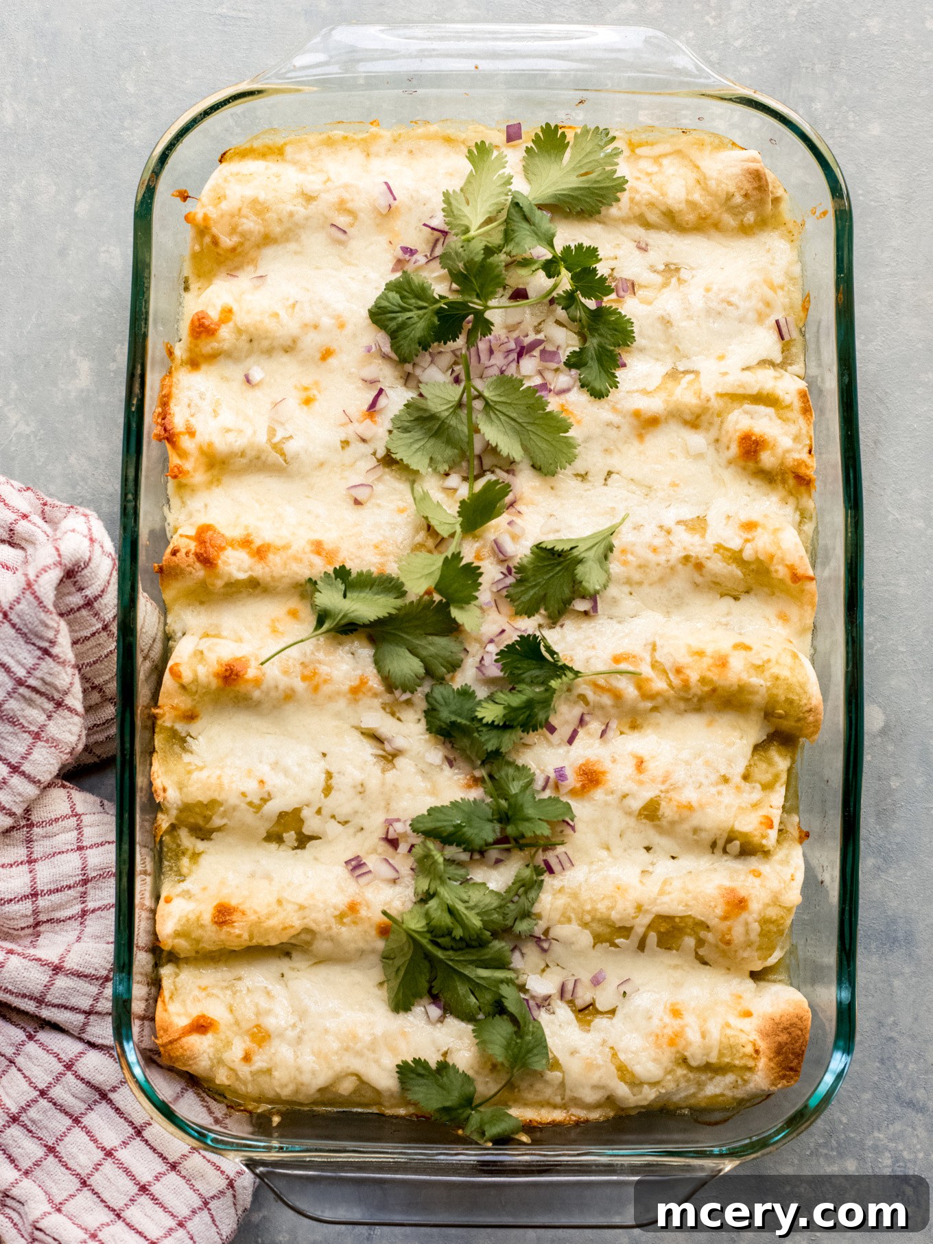 Delicious Enchiladas Verdes baked in a glass dish, ready to serve.