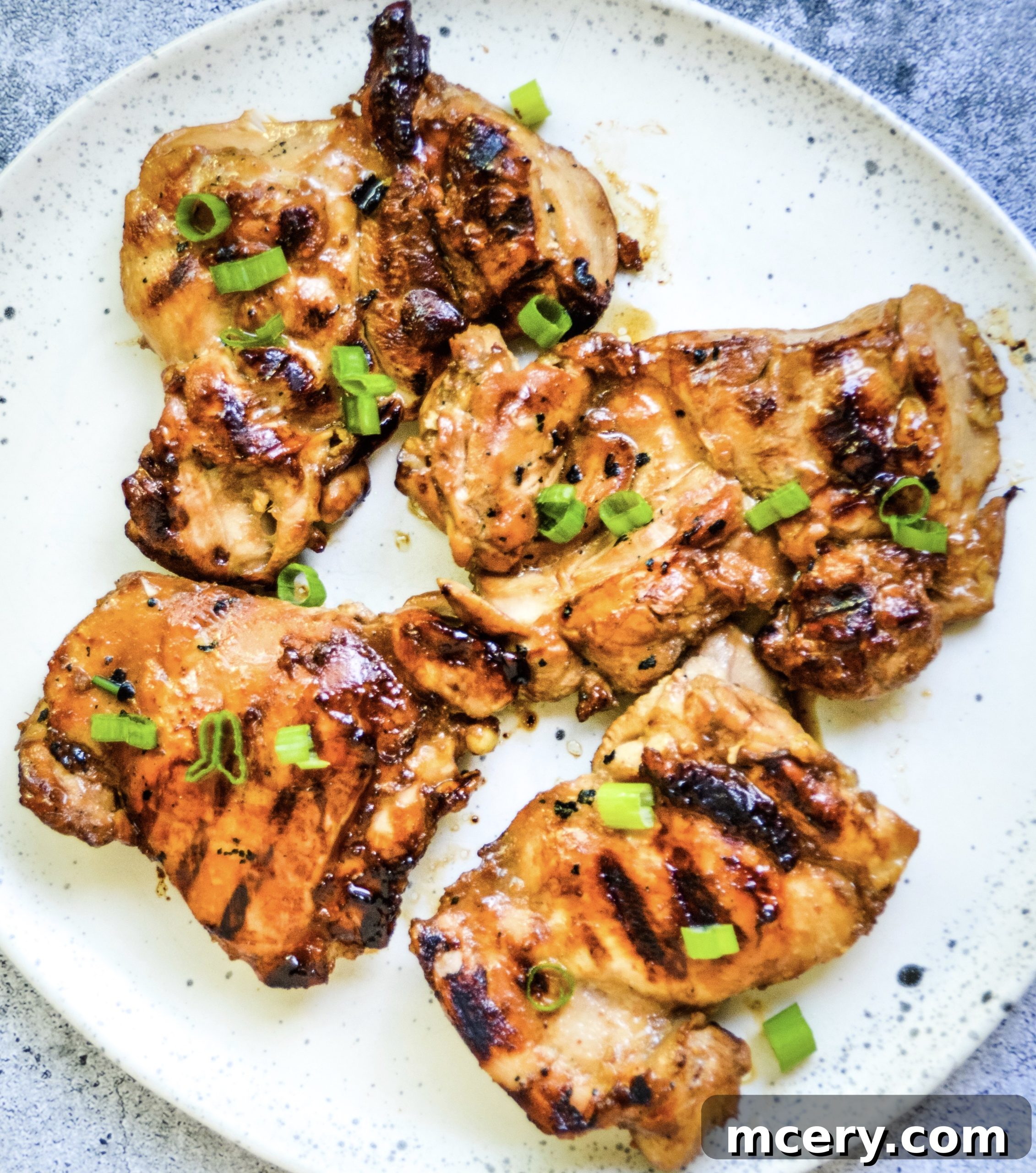 A variety of grilled chicken pieces on a serving platter, showing different cuts and preparation, inviting viewers to explore more chicken recipes.