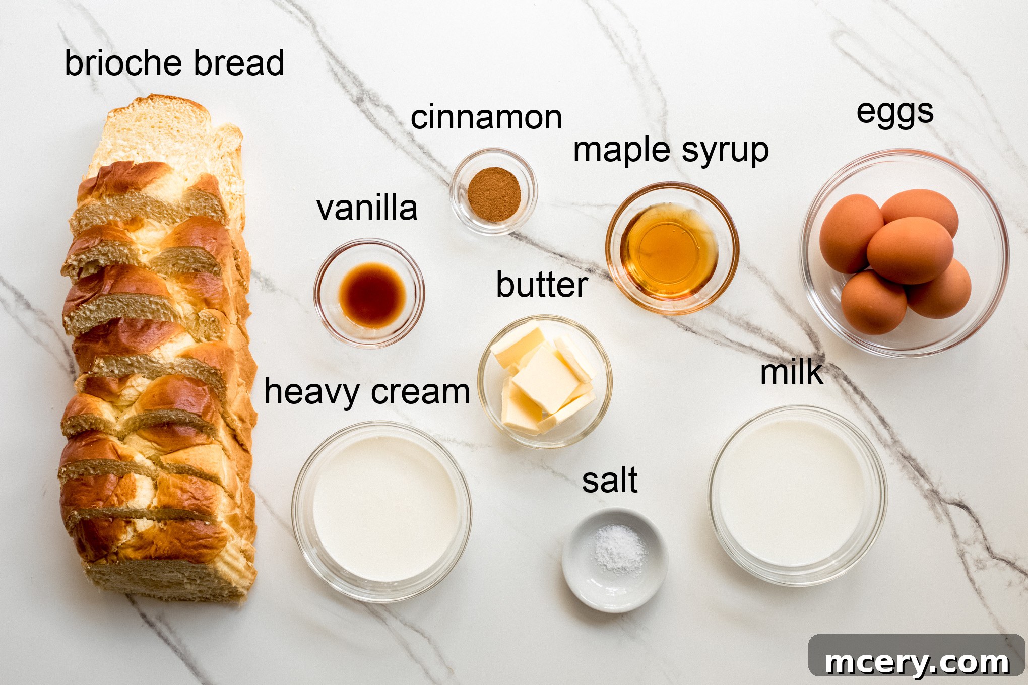Golden Brioche French Toast Perfection 4 A collection of ingredients for French toast, including eggs, milk, brioche bread, and spices.