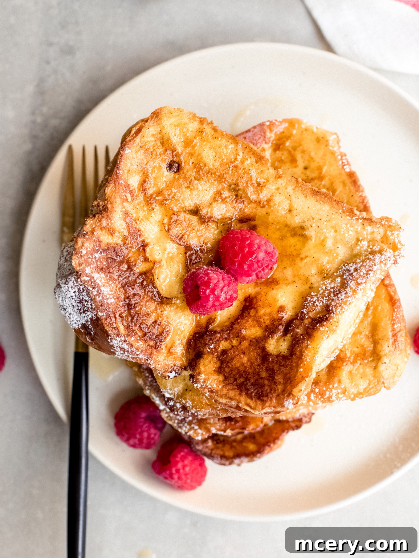 Golden Brioche French Toast Perfection 8 Close-up of a single brioche French toast slice on a plate with a fork.