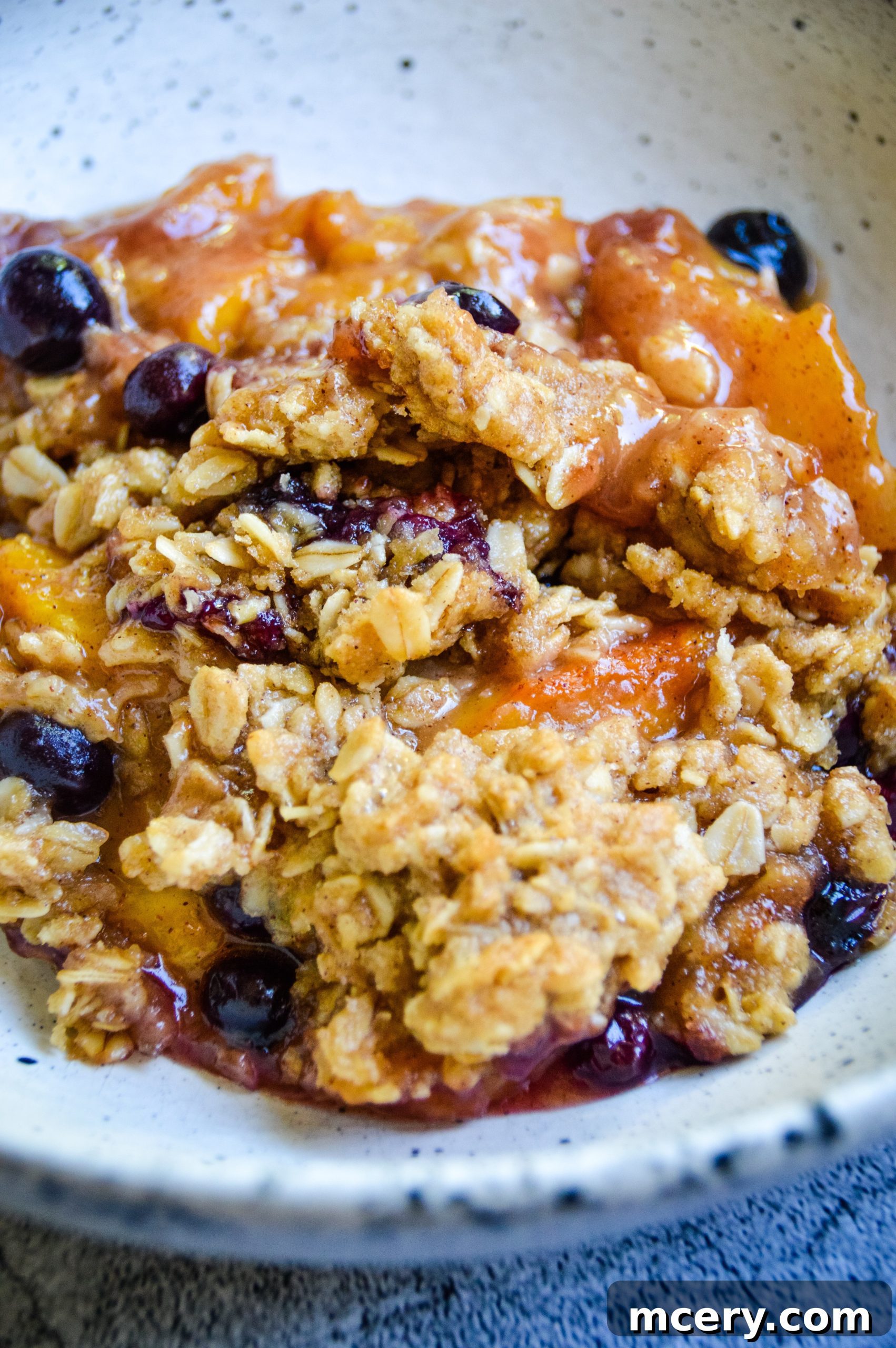Sunshine Peach Blueberry Crisp 2 Freshly baked Peach Blueberry Crisp, golden brown and bubbling, ready to be served.