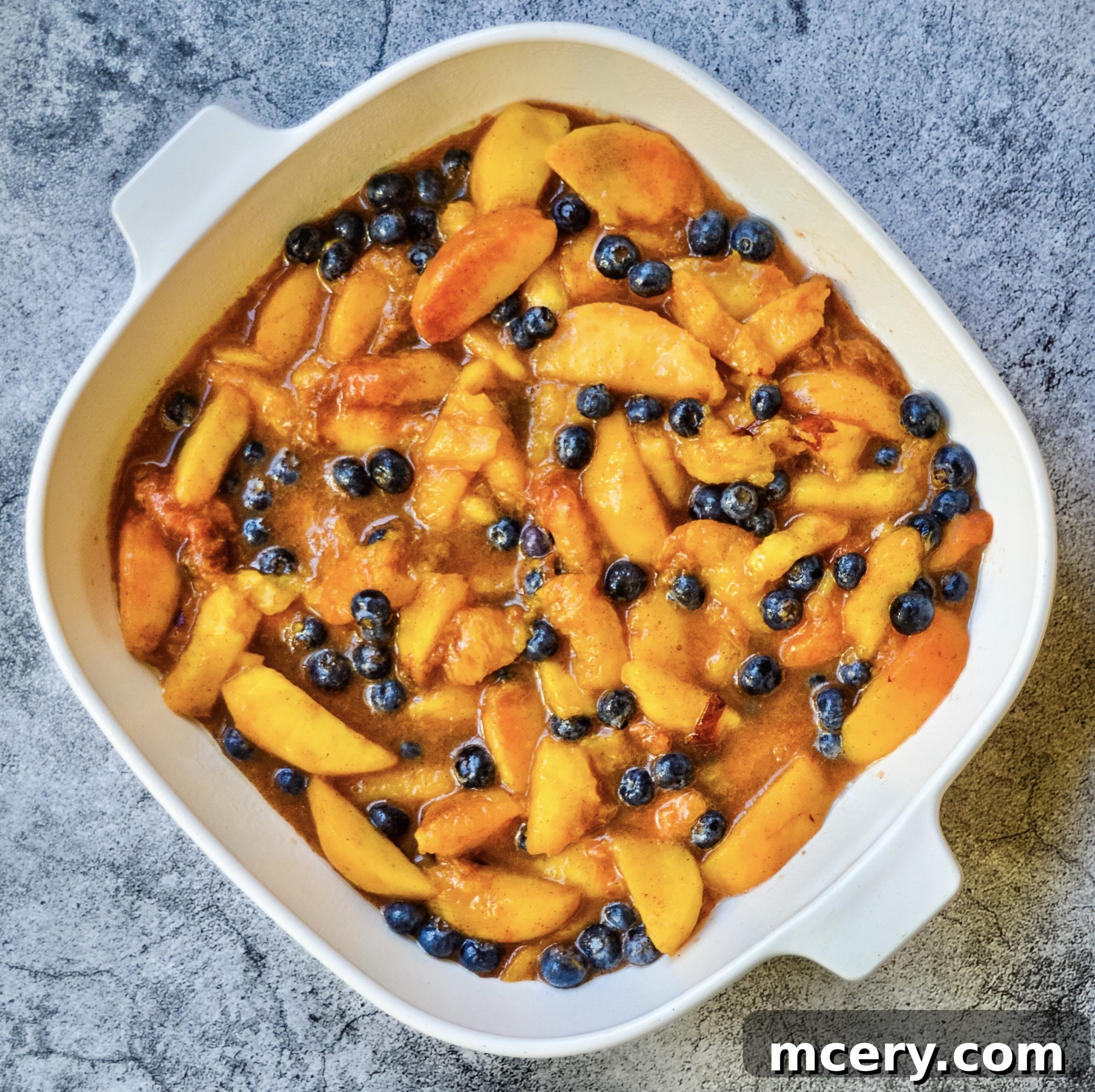 Sunshine Peach Blueberry Crisp 3 Close-up of the Peach Blueberry Crisp filling with fresh peaches and blueberries.