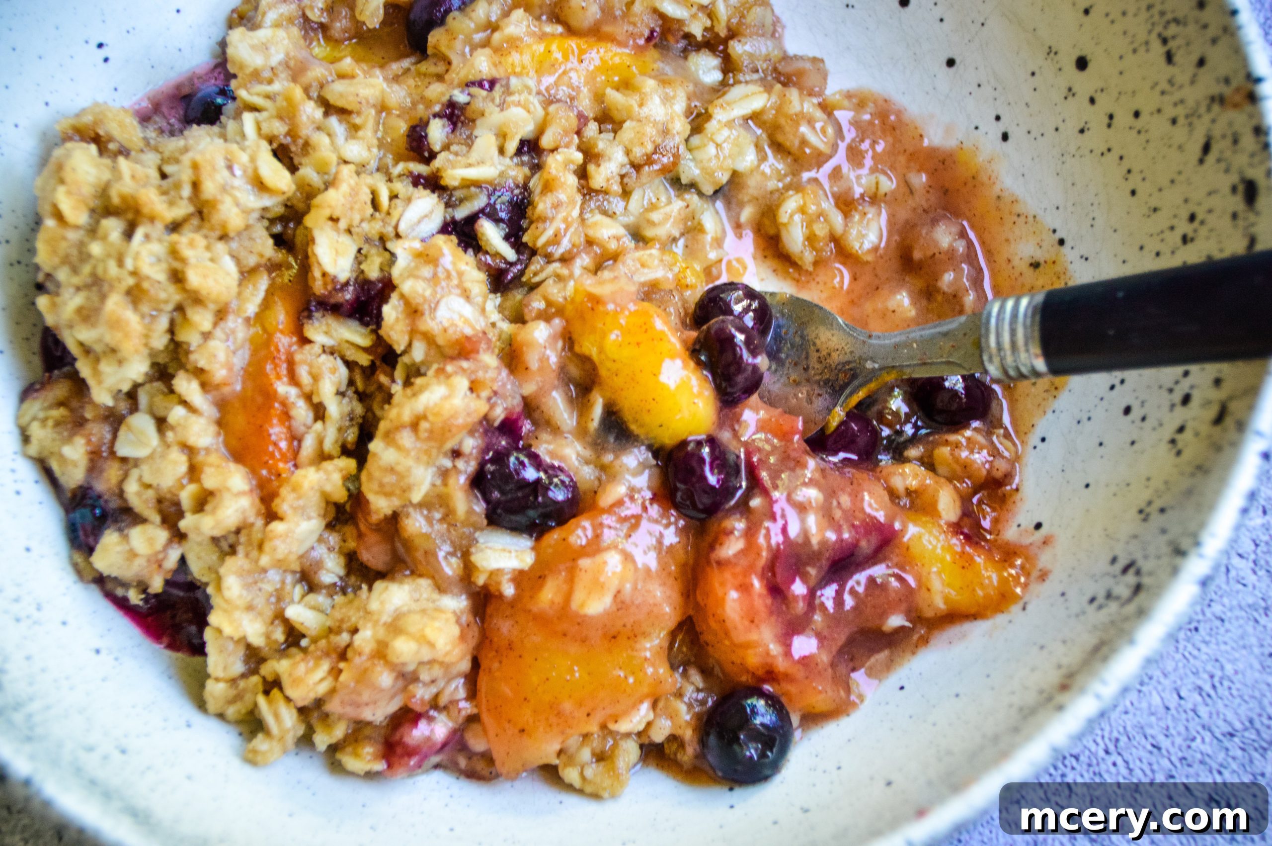 Sunshine Peach Blueberry Crisp 5 A close-up of the crisp topping ingredients, showing oats, flour, and brown sugar.