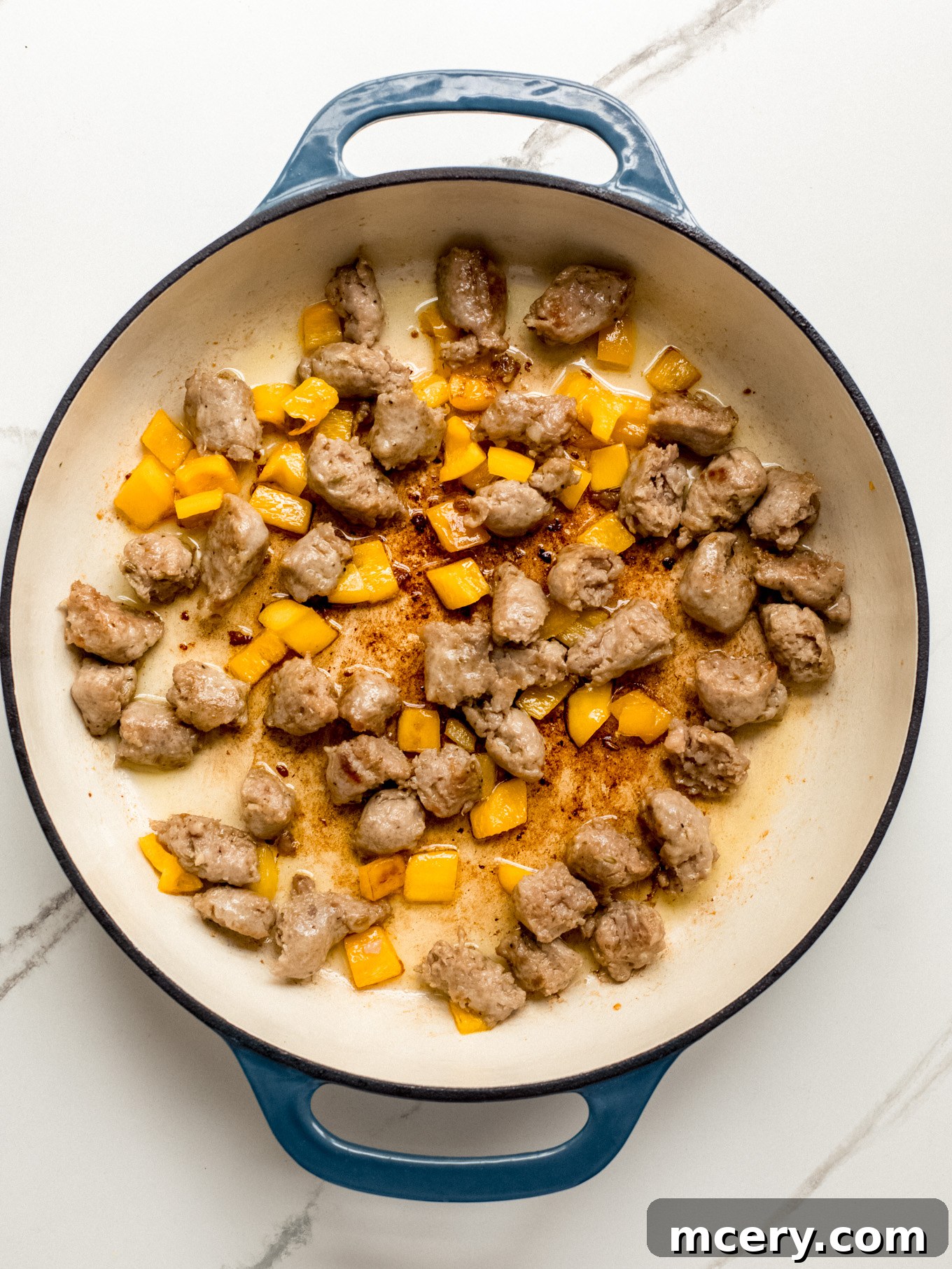 Irresistible Creamy Cajun Sausage Pasta 6 cooked Italian sausage and bell pepper in a saute pan.