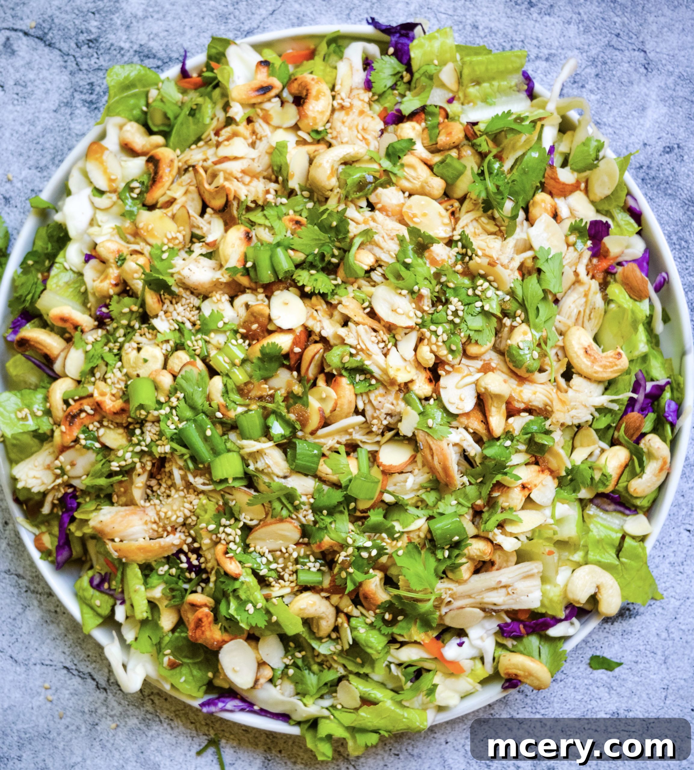 Close-up of the Chinese Chicken Chopped Salad, showcasing the finely chopped ingredients like red cabbage, green onions, chicken, and a glistening dressing.