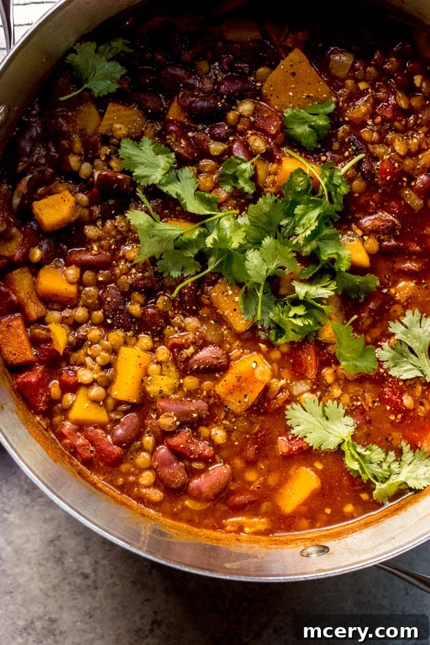 Butternut Bliss Chili 7 Close-up of a pot of butternut squash lentil chili, showcasing its thick, rich texture and vibrant ingredients.