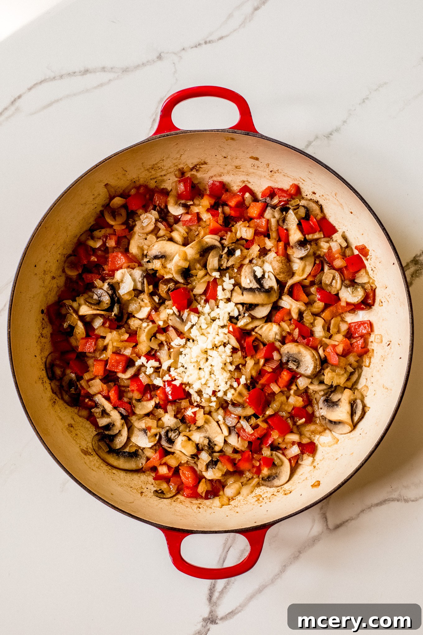 Hearty Italian Sausage and Pepper Skillet 6 cooked vegetables with garlic in a pan.
