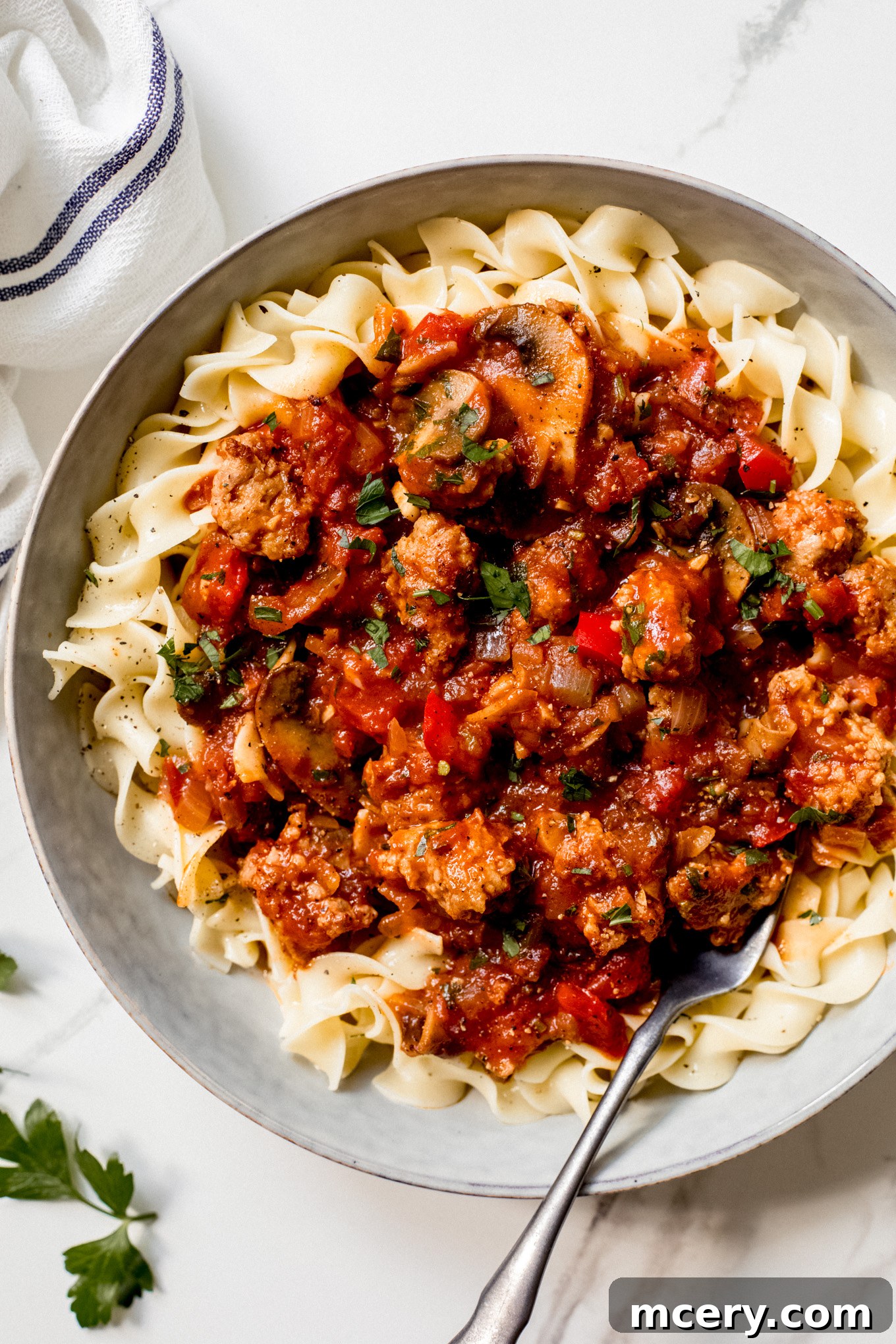 Hearty Italian Sausage and Pepper Skillet 10 sausage cacciatore over cooked egg noodles.