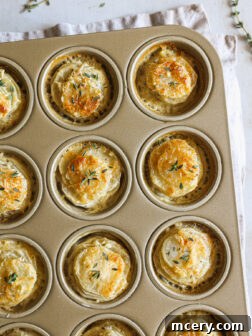 Baked potato stacks in a muffin pan, golden and ready to serve.