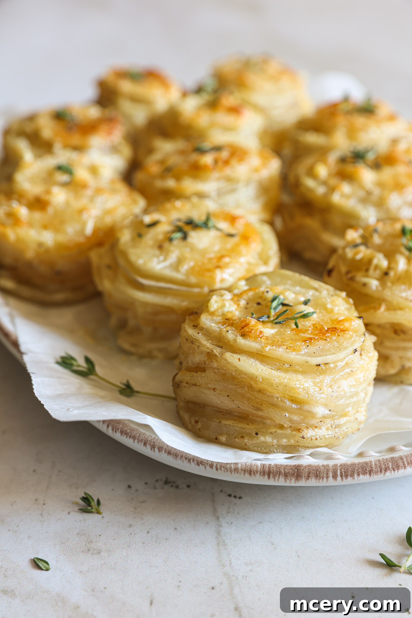 Close-up side view of golden-brown baked muffin pan potatoes, perfectly stacked.