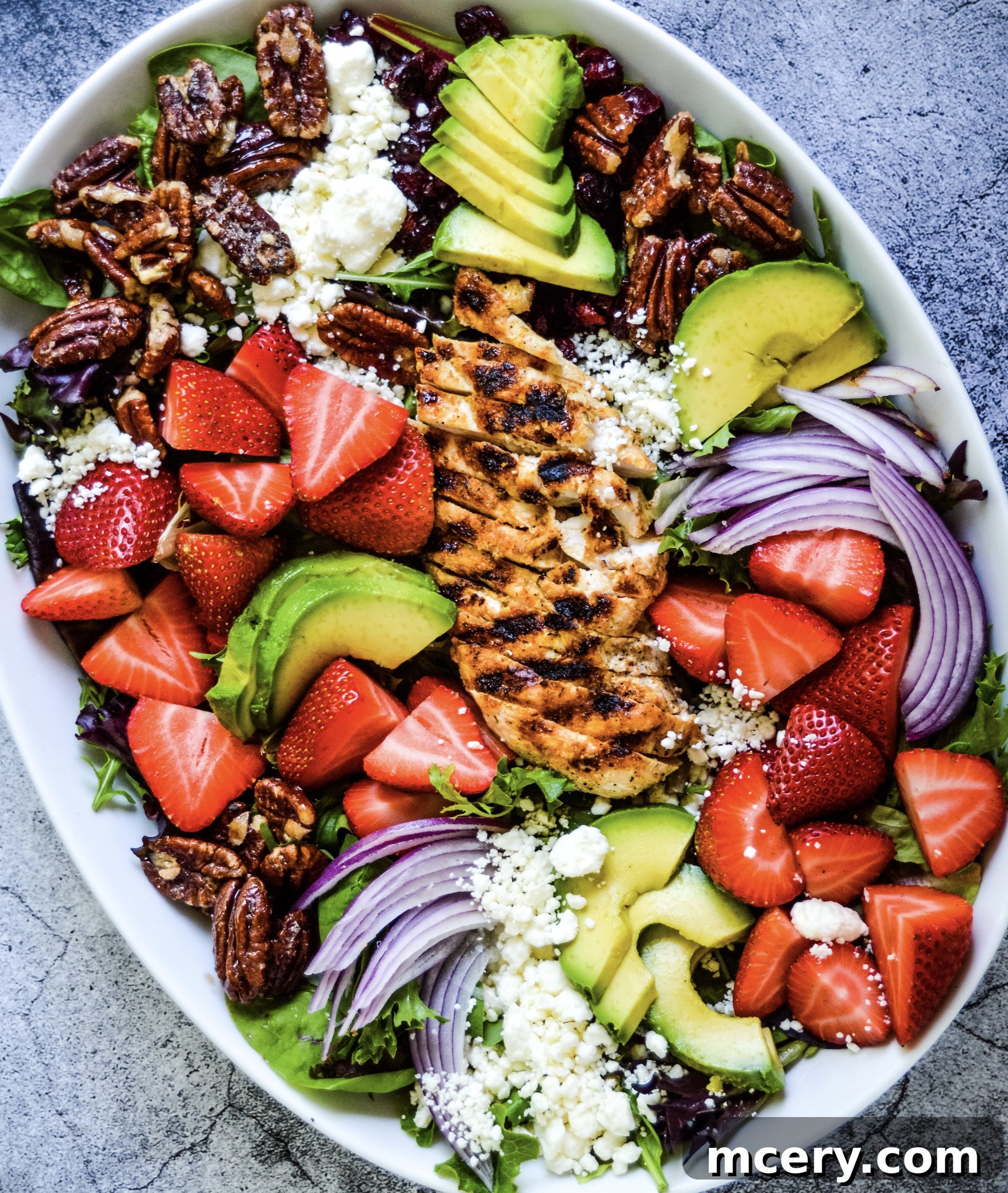Vibrant Strawberry Fields Salad featuring grilled chicken, fresh strawberries, and feta cheese.