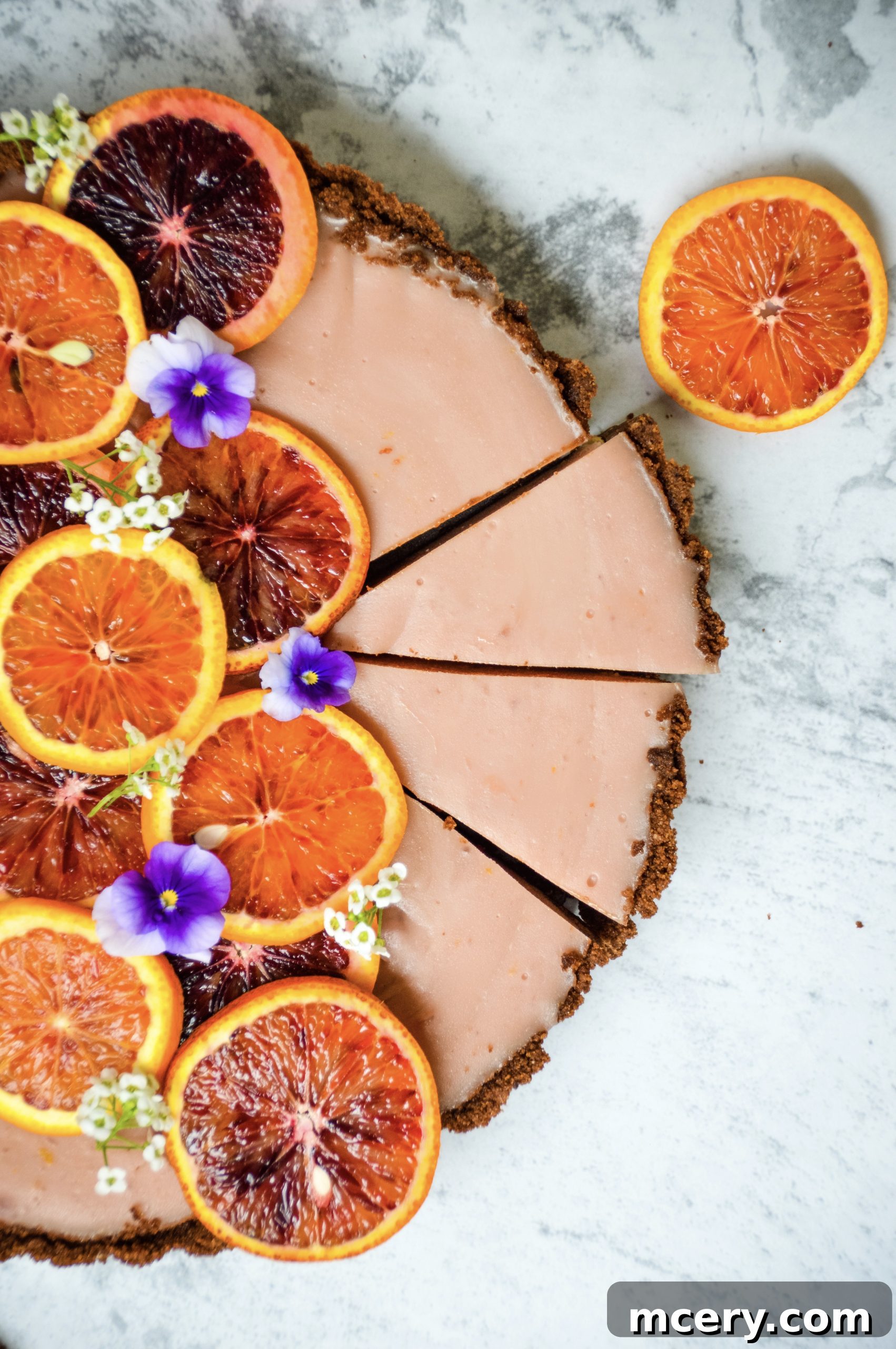 Zesty Blood Orange Tart 3 A vibrant close-up of the blood orange tart's smooth, glistening filling, perfectly set within its chocolate crust.
