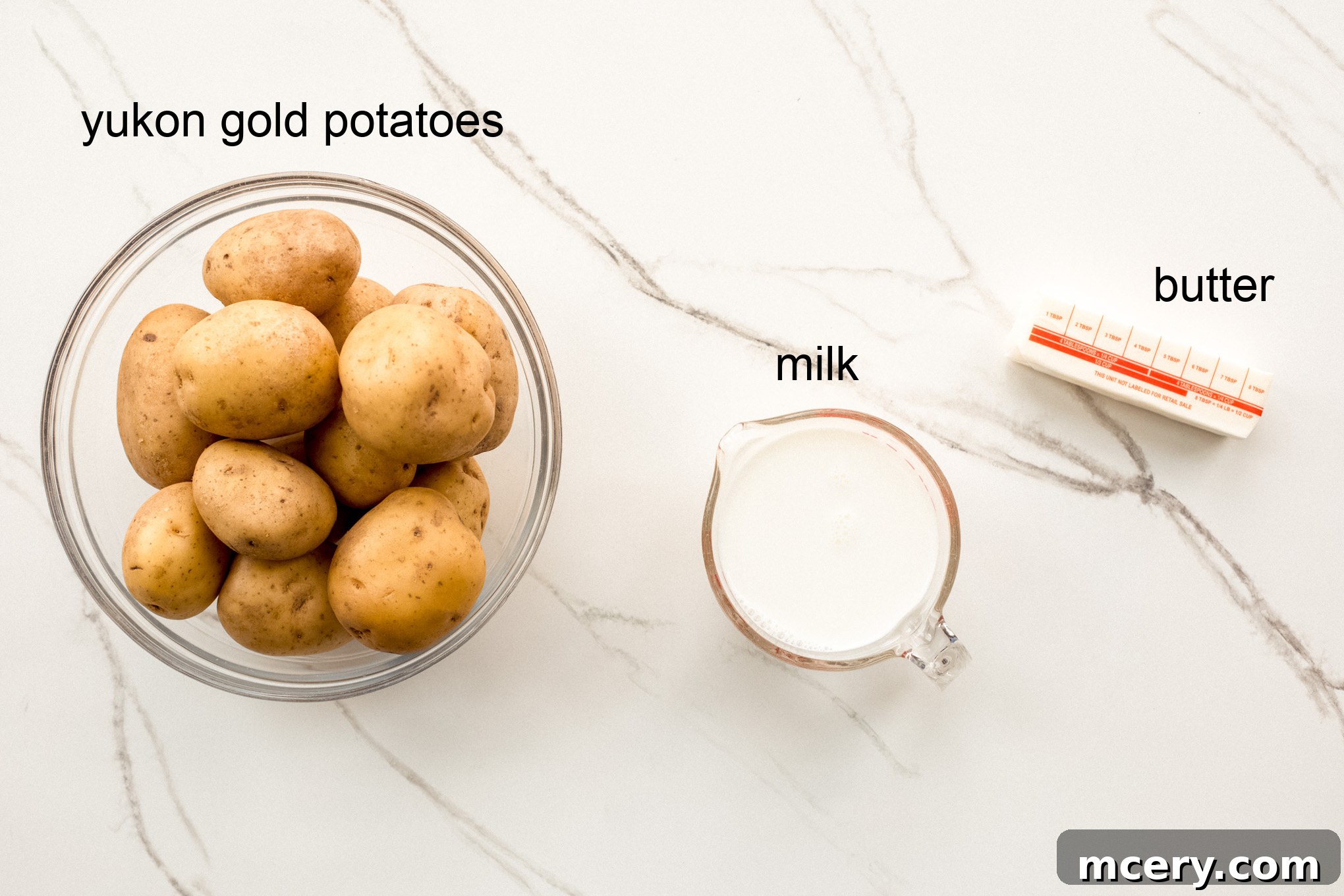 Silky Yukon Gold Mash 3 Ingredients for mashed potatoes, including whole Yukon Gold potatoes, butter, and milk.