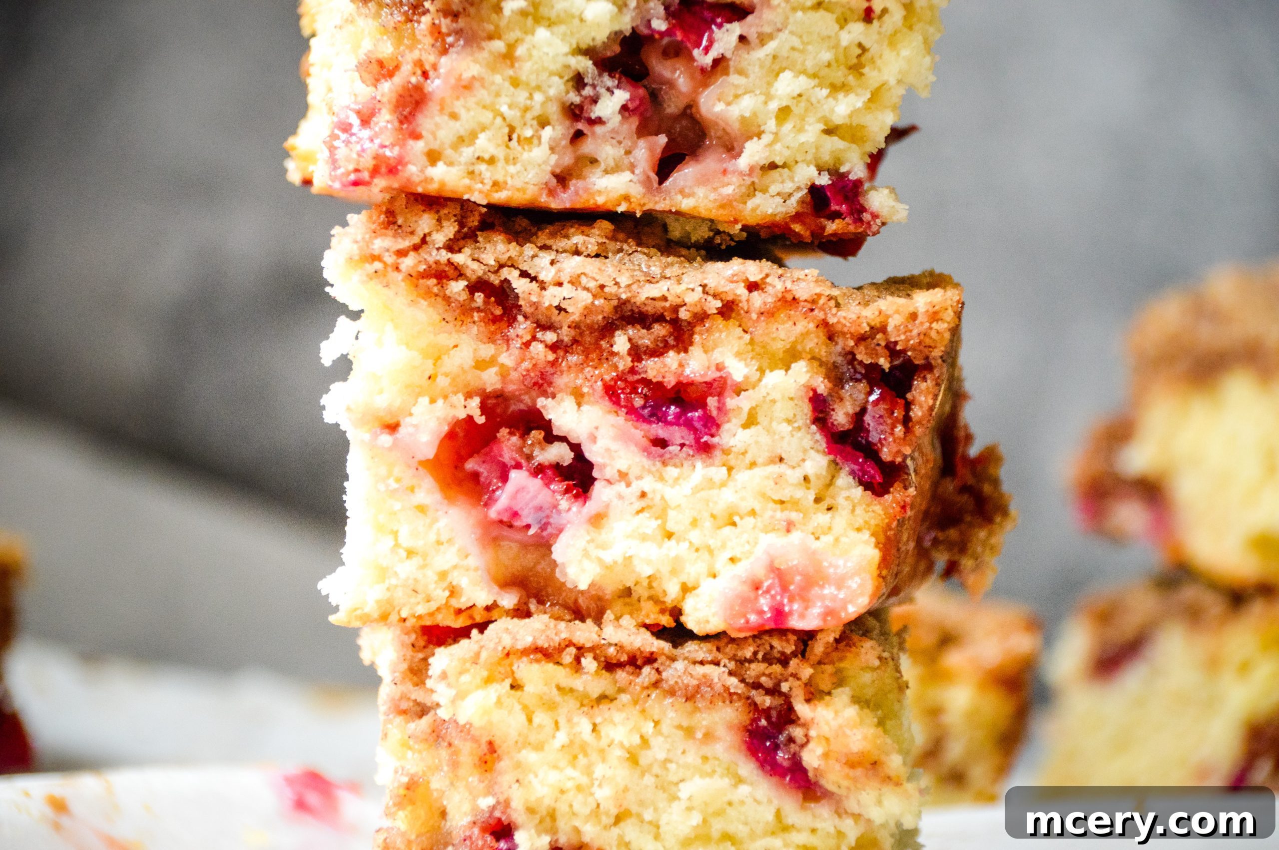 Strawberry Crumb Coffee Cake 10 A freshly baked Strawberry Coffee Cake, cut into squares, showcasing the golden-brown streusel and the moist, fruit-filled interior, ready to be served.