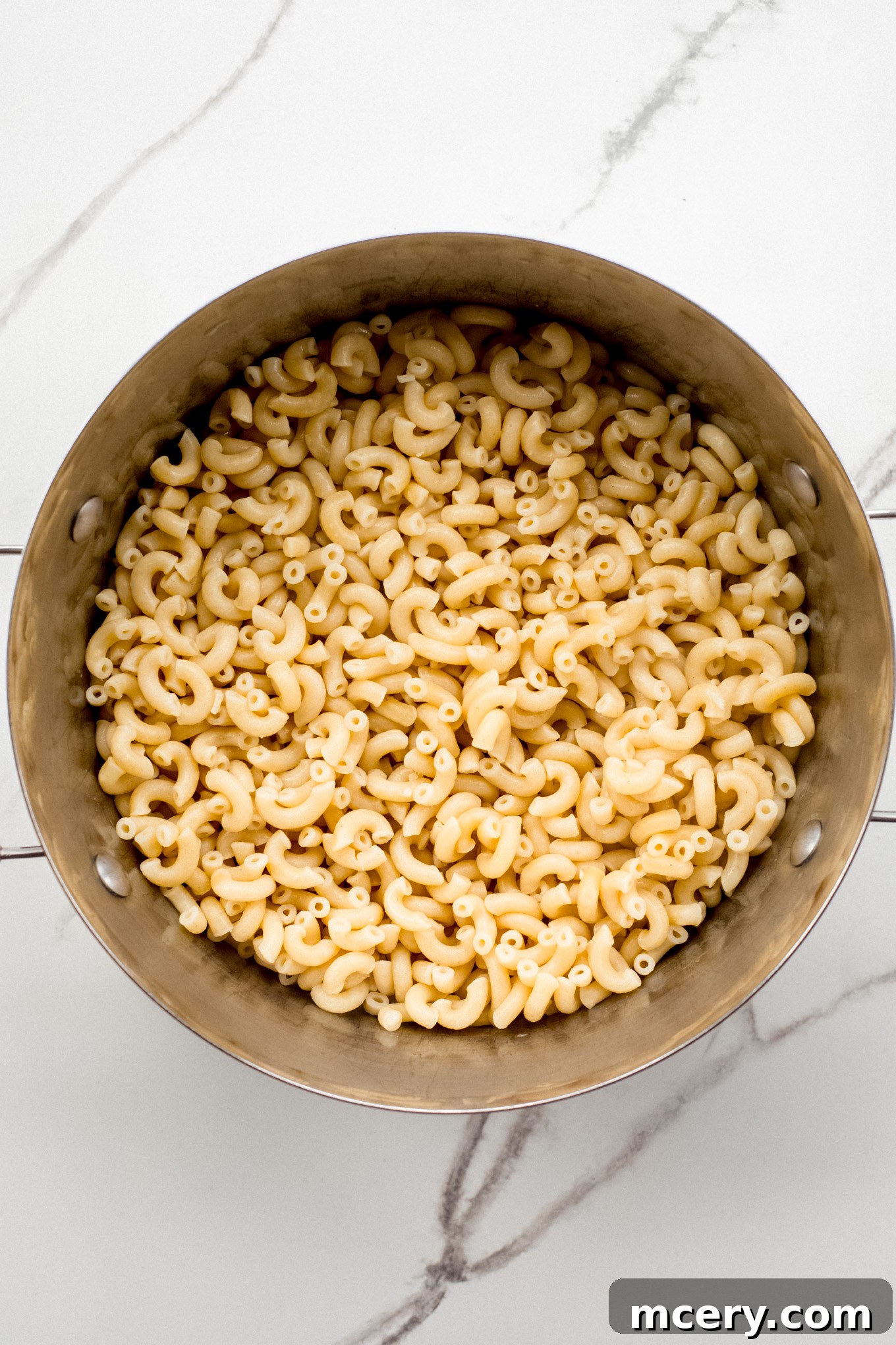 Velvet Smoked Gouda Mac 4 cooked macaroni in a pot.