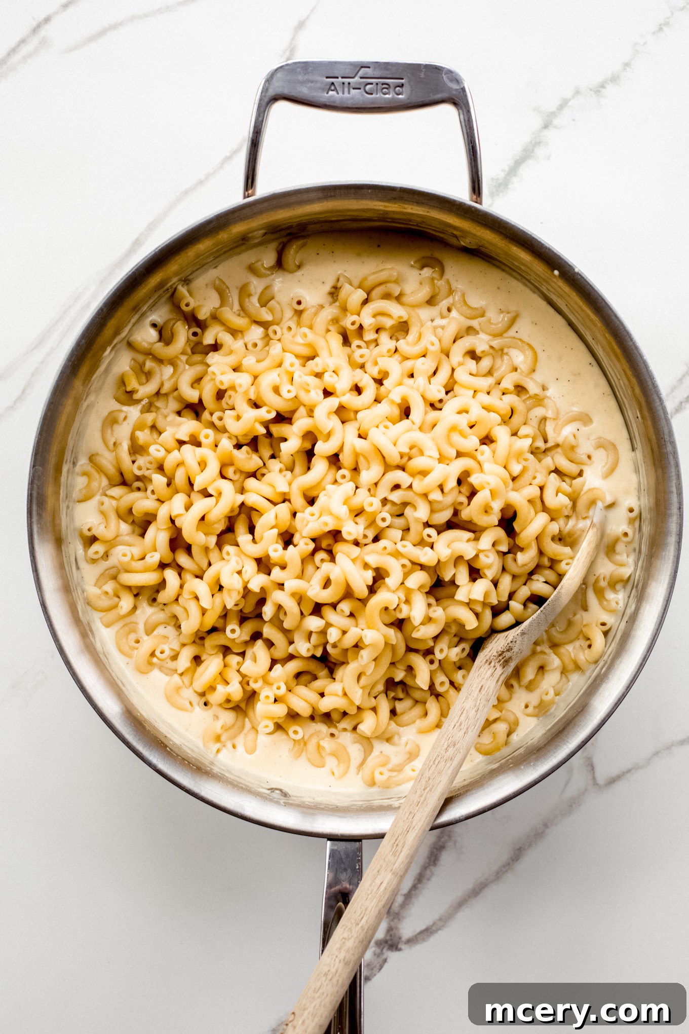 Velvet Smoked Gouda Mac 8 cooked macaroni with cheese sauce in a pan.