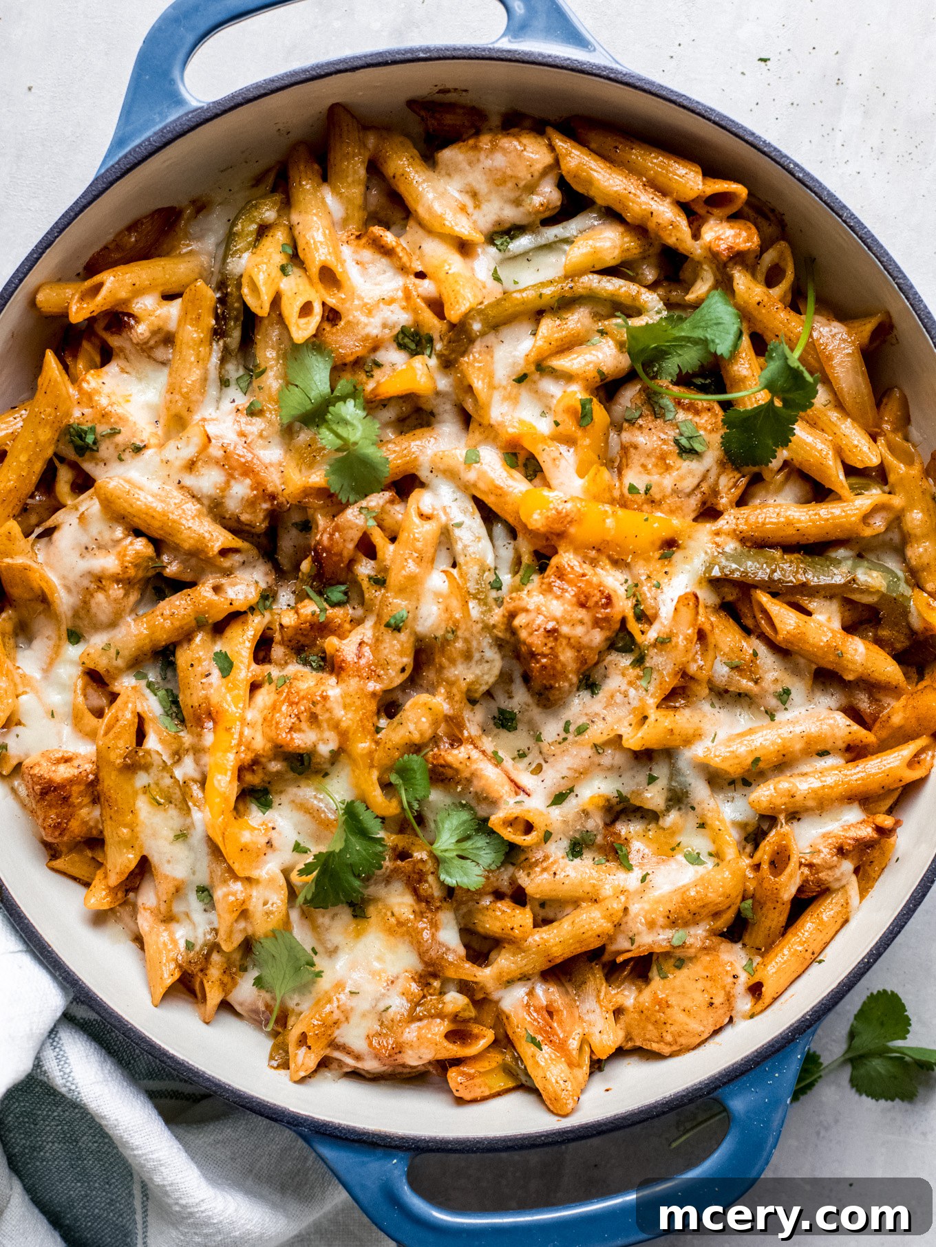 Creamy Chicken Fajita Pasta 2 chicken fajita pasta in a pan garnished with cilantro.