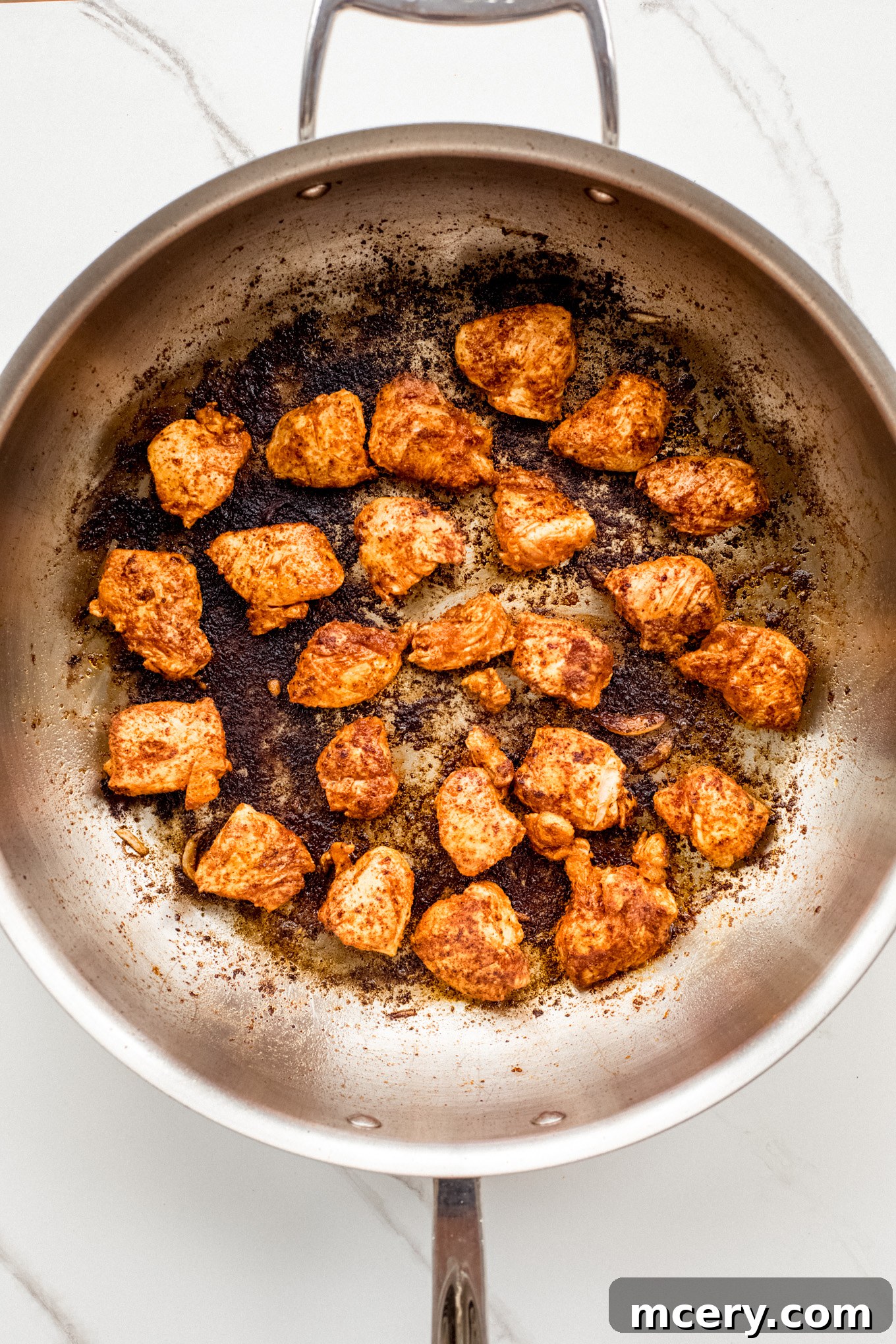 Creamy Chicken Fajita Pasta 8 cooked chicken pieces in a saute pan.