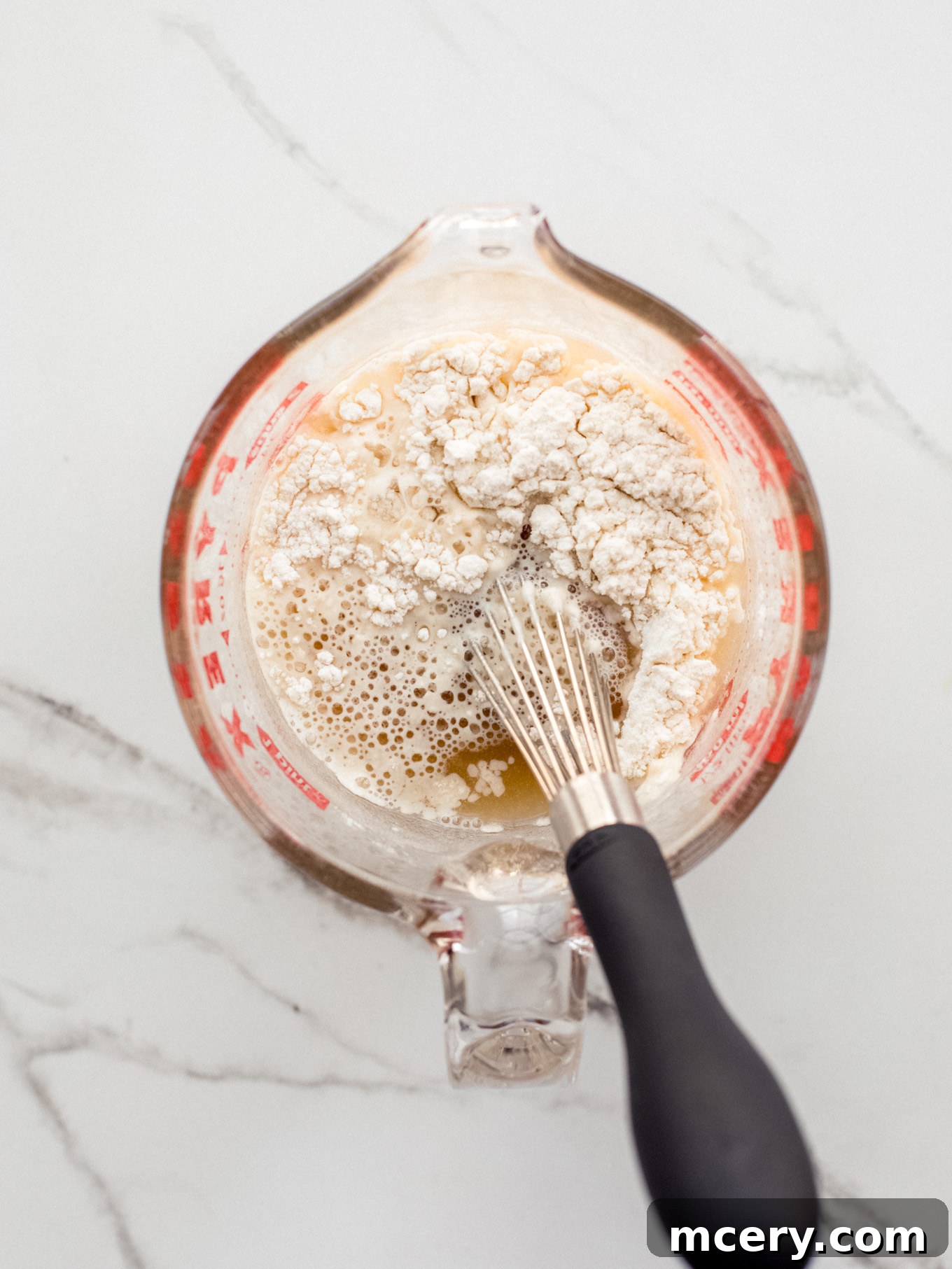 Easy Weeknight Mushroom Stroganoff 6 Vegetable stock and all-purpose flour being whisked together in a measuring cup to form a slurry.