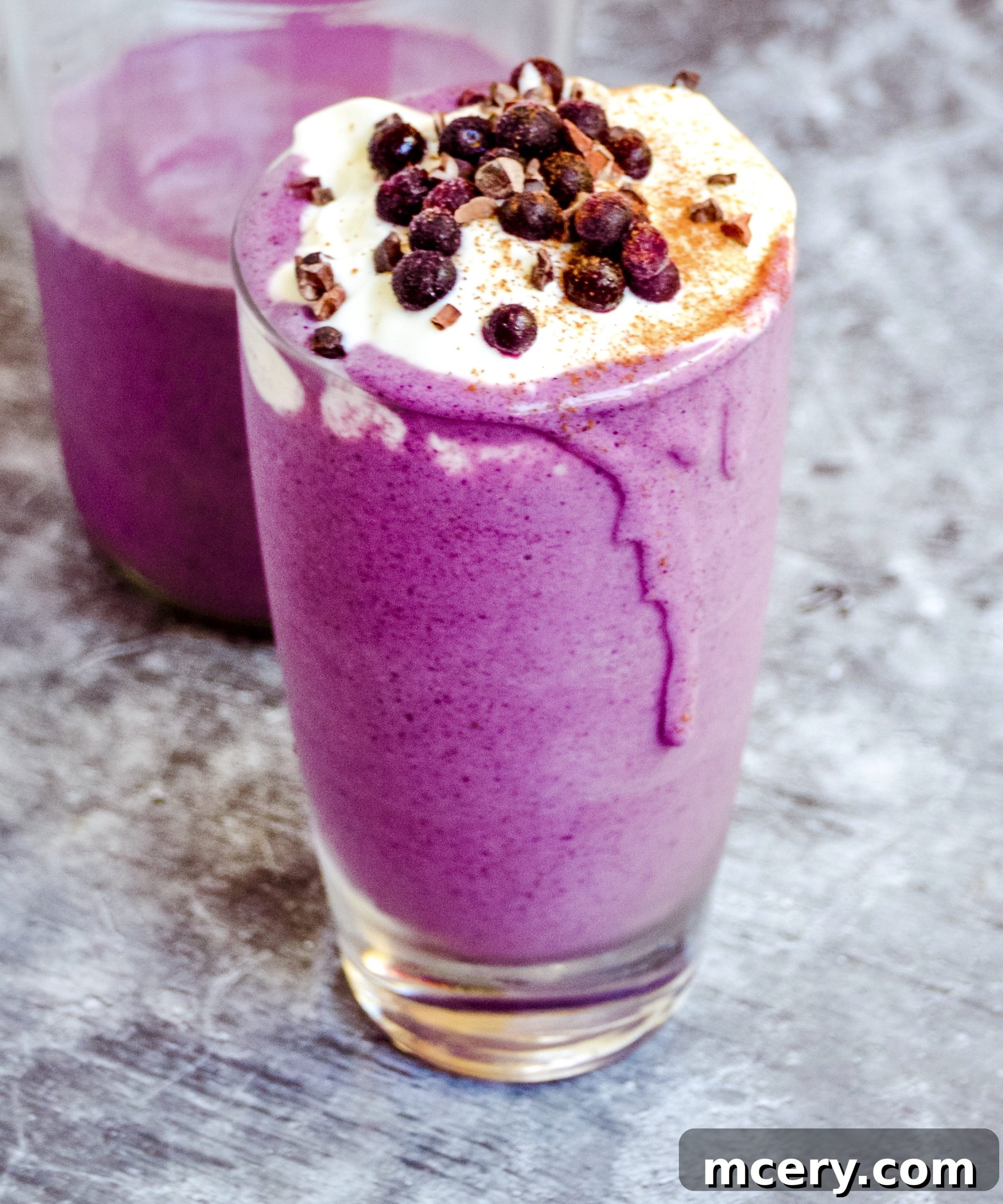A close-up shot of the creamy blueberry smoothie in a glass, showcasing its thick and inviting texture.