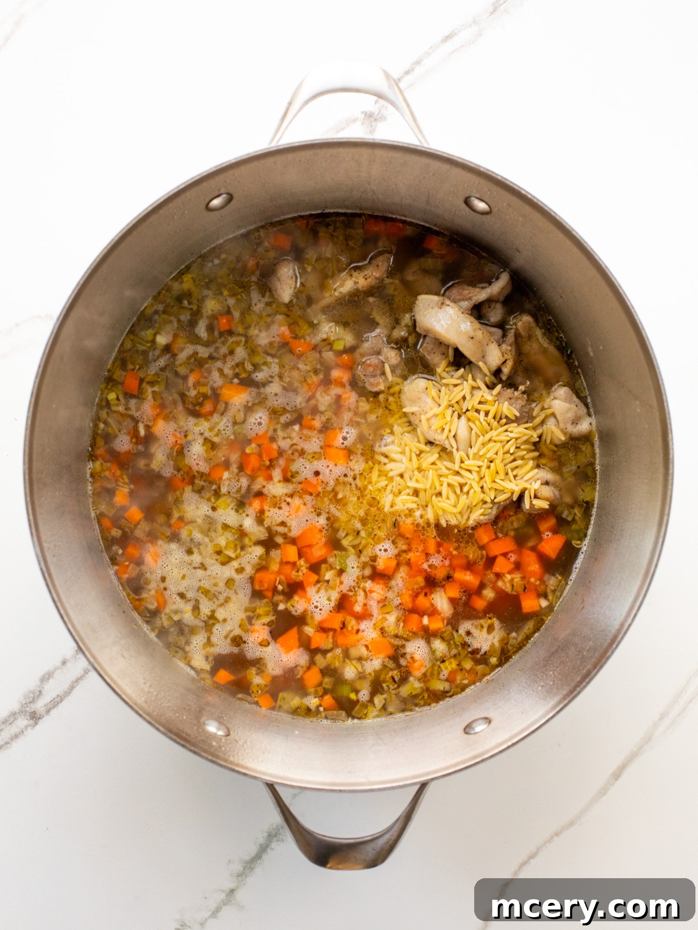 Hearty Chicken Orzo Soup 6 chicken and orzo in a dutch oven with chicken stock.
