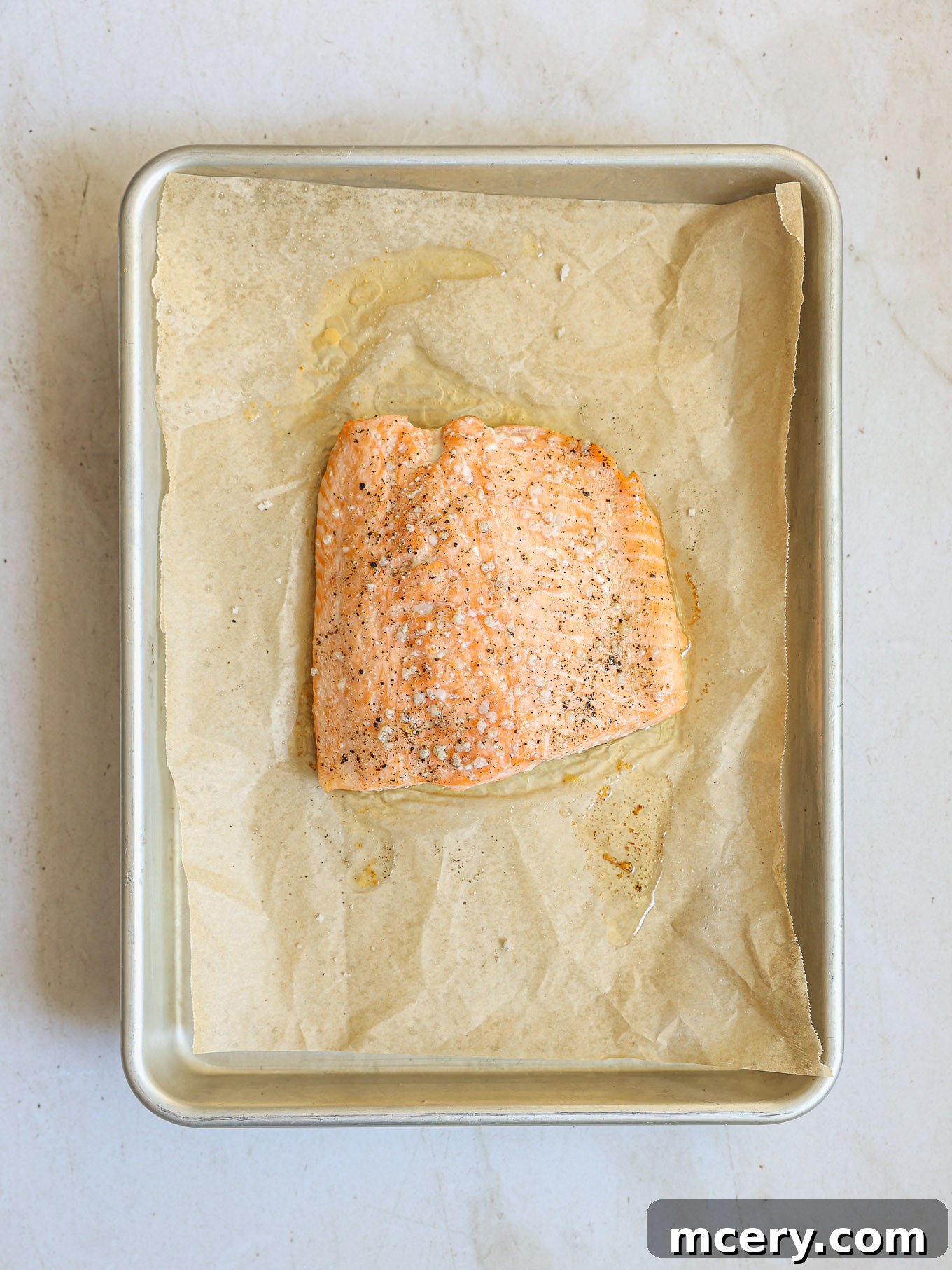 baked salmon fillet on a baking sheet, golden and flaky.