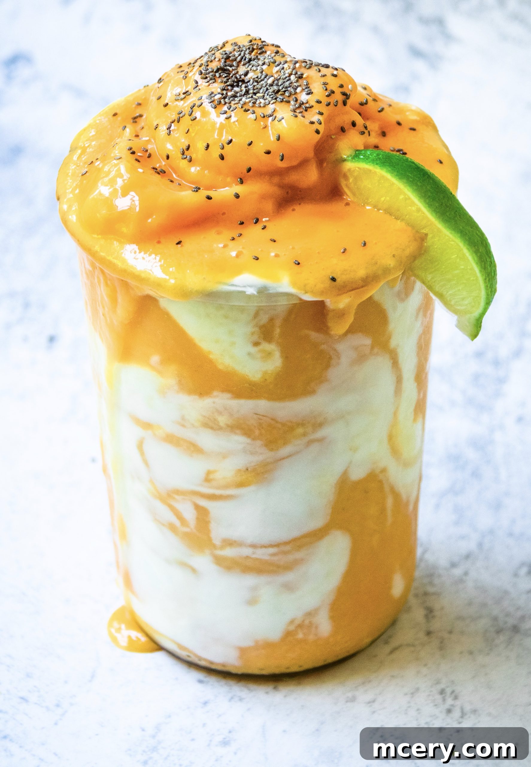 Close-up of a Papaya Dream Smoothie in a glass, topped with chia seeds, highlighting its creamy texture.