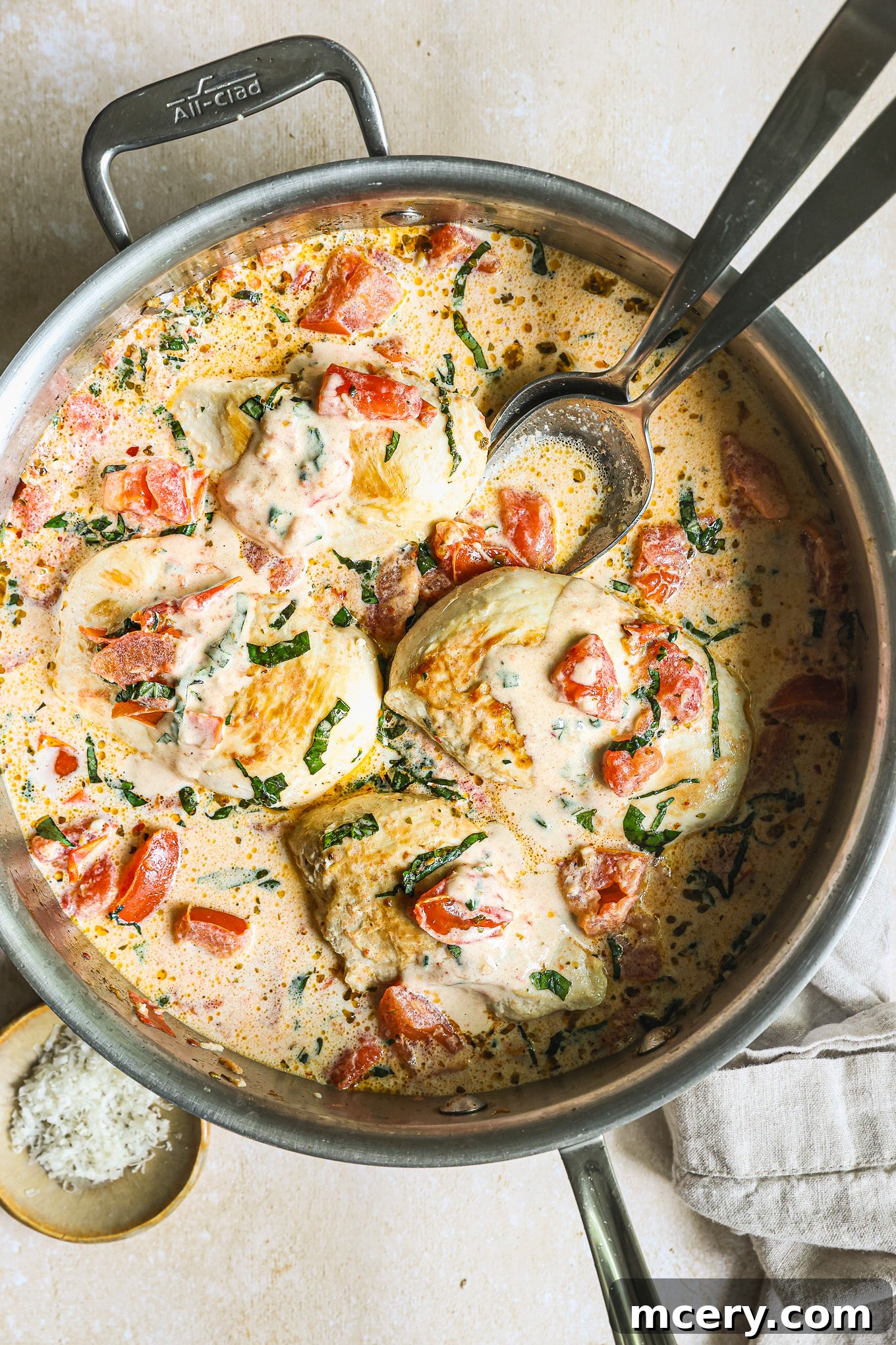 Sun-Kissed Tomato Basil Chicken 2 chicken breast topped with tomato cream sauce in a saute pan.