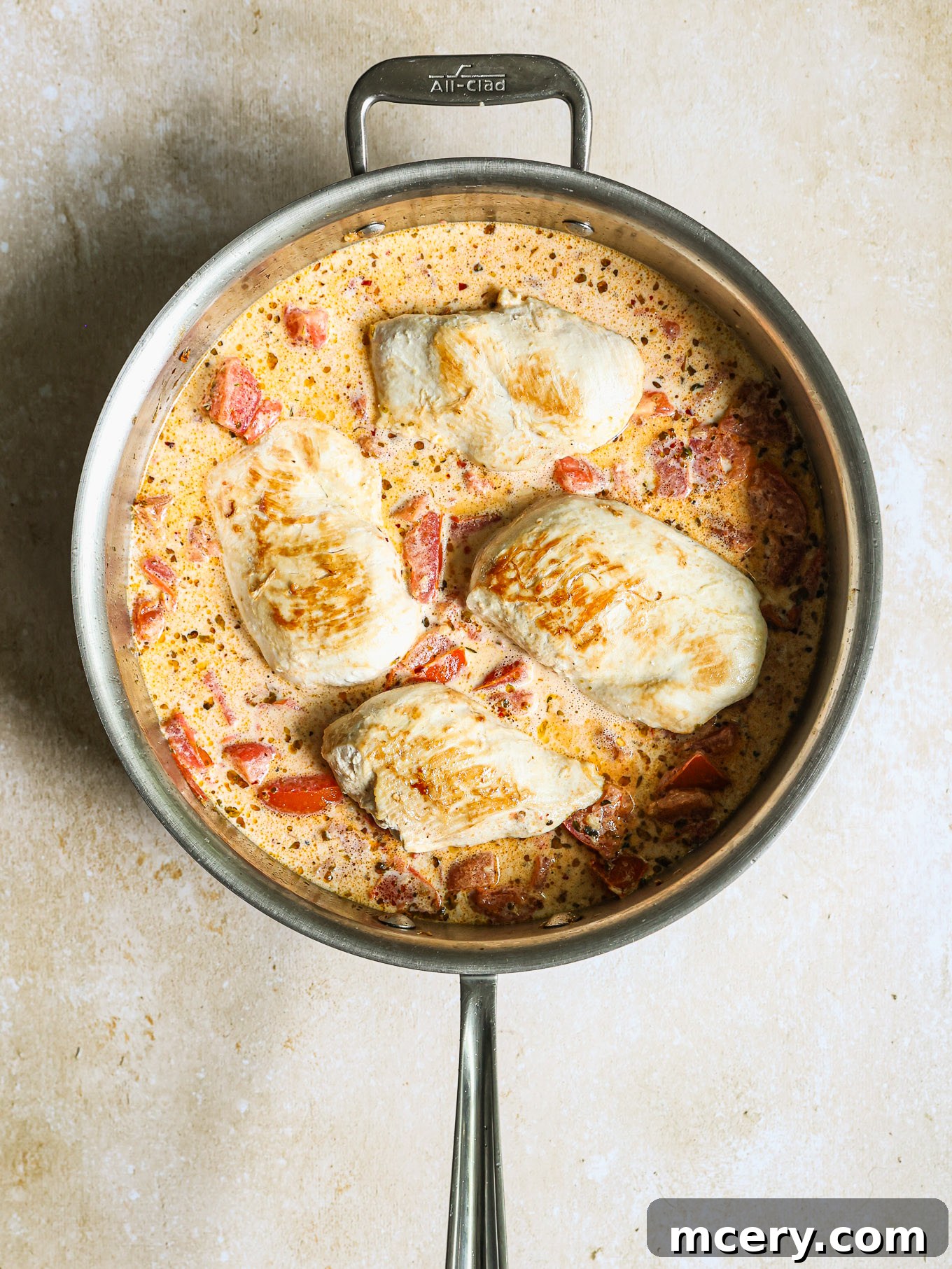 Sun-Kissed Tomato Basil Chicken 6 chicken breast with cream sauce in a pan.