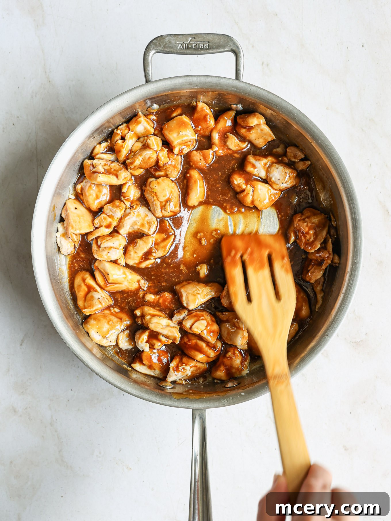 Whip Up Delicious Homemade Chicken Teriyaki 9 Fully coated teriyaki chicken simmering in the skillet, ready to be garnished.