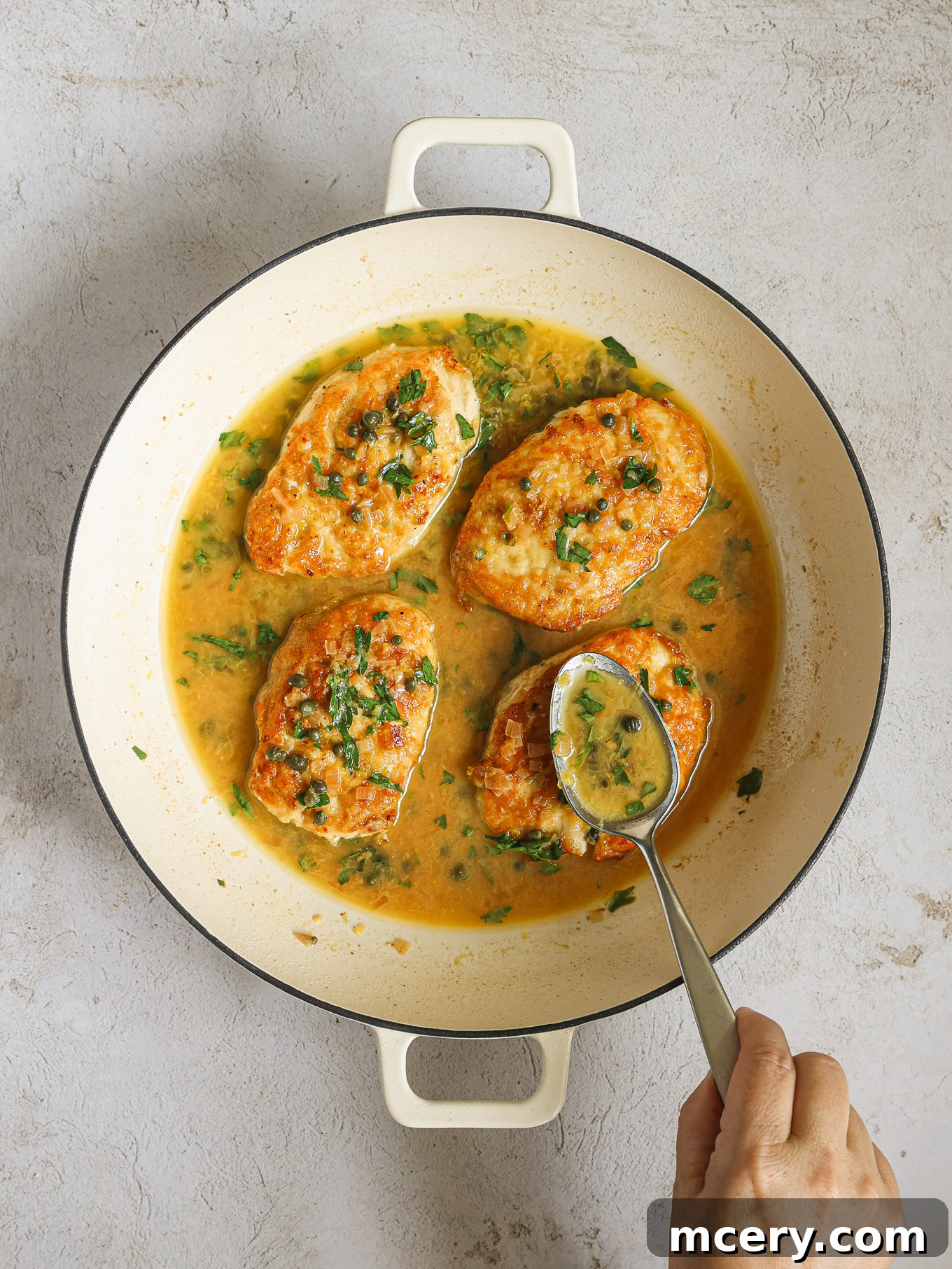 Zesty Lemon Piccata Chicken 11 lemon caper sauce spooned over chicken.