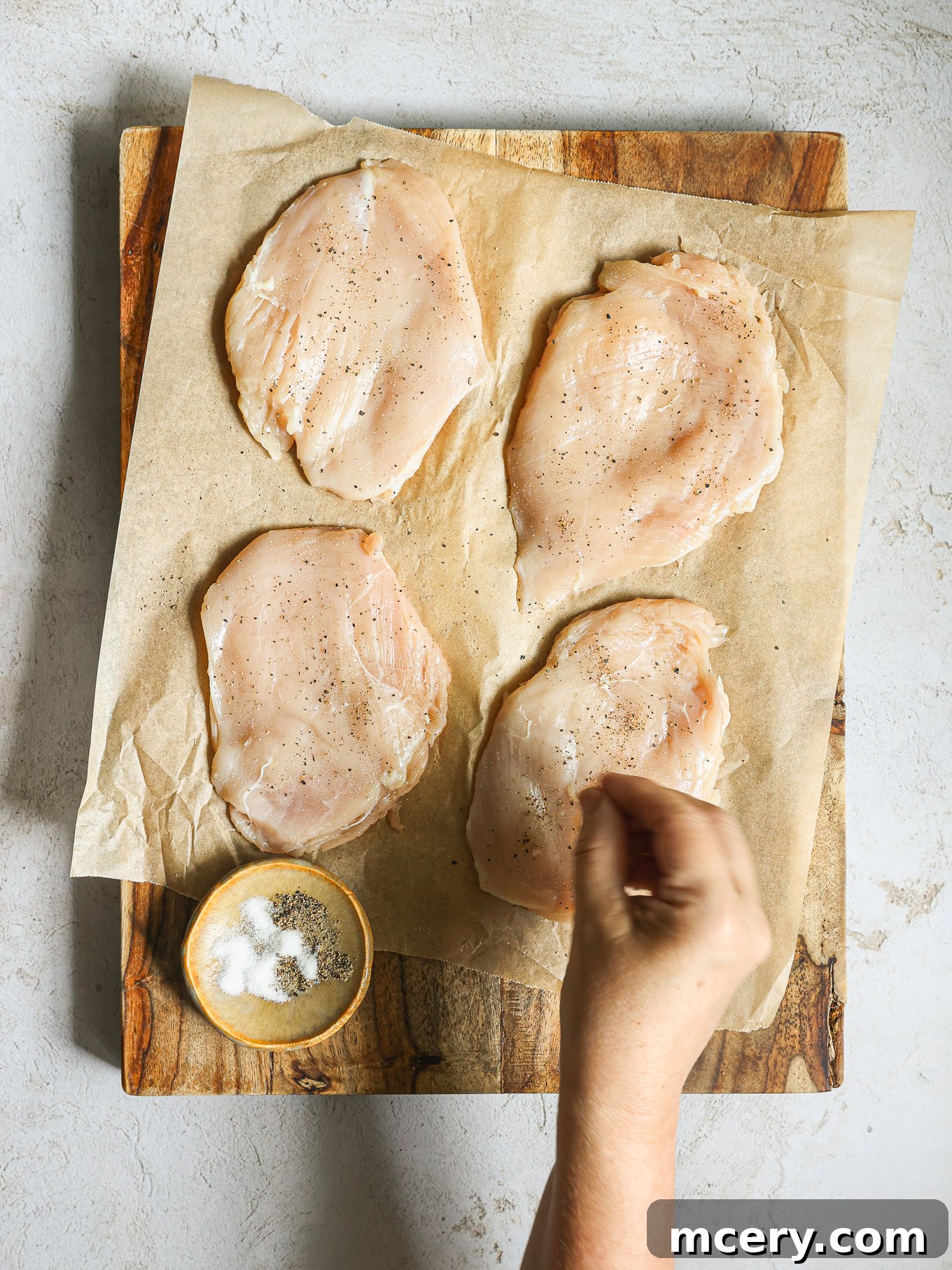 Zesty Lemon Piccata Chicken 4 chicken breast on a cutting board.