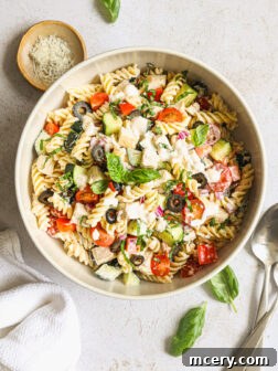 pasta salad with chicken in a white bowl.