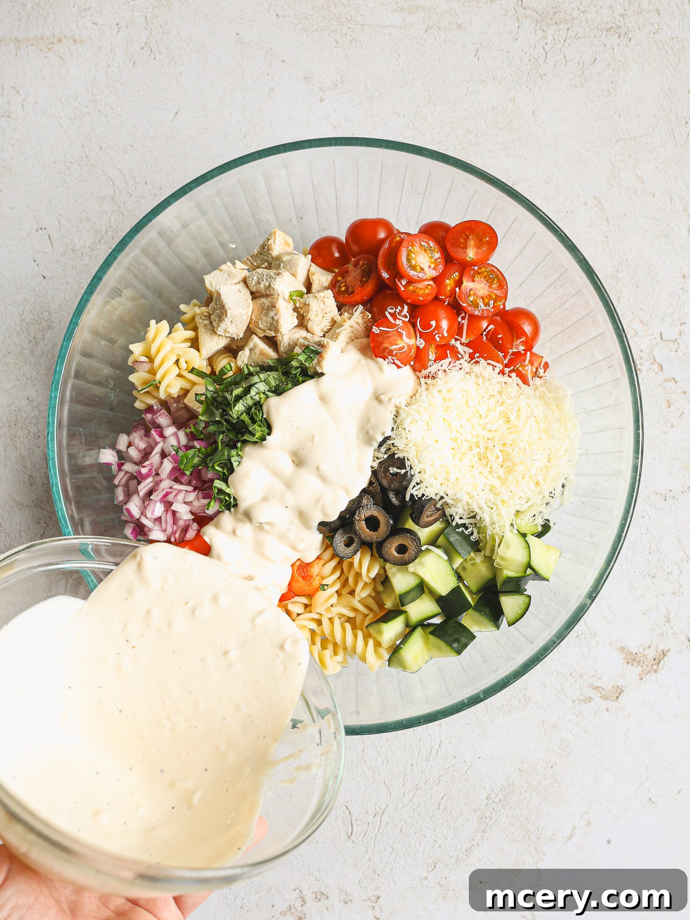 Flavorful Chicken Pasta Salad 7 pasta salad covered with dressing in a glass bowl.