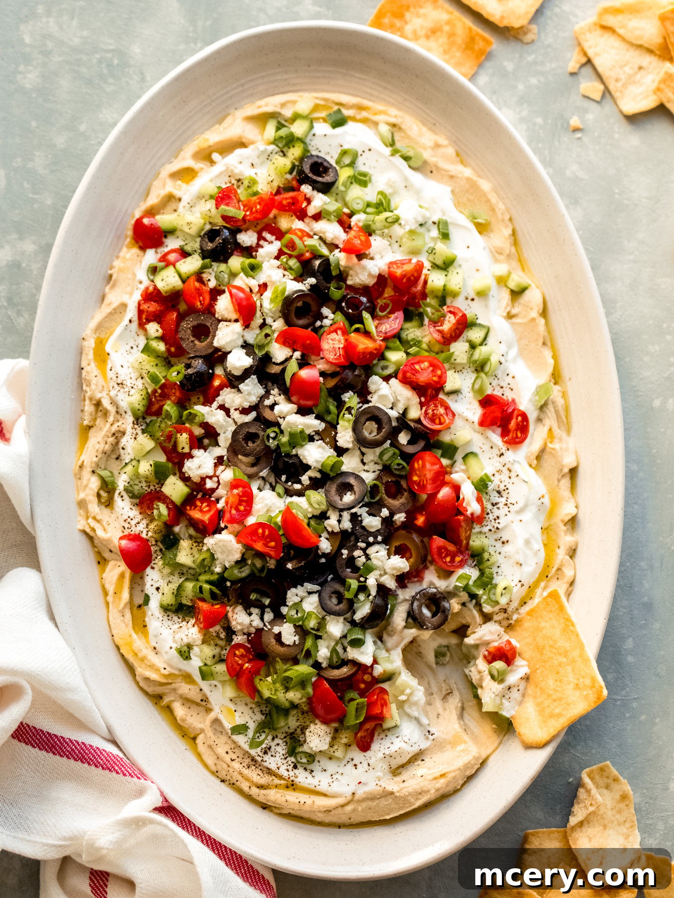Stacked Hummus Delight 8 Beautifully presented creamy hummus dip with Greek yogurt, fresh veggies, and feta cheese