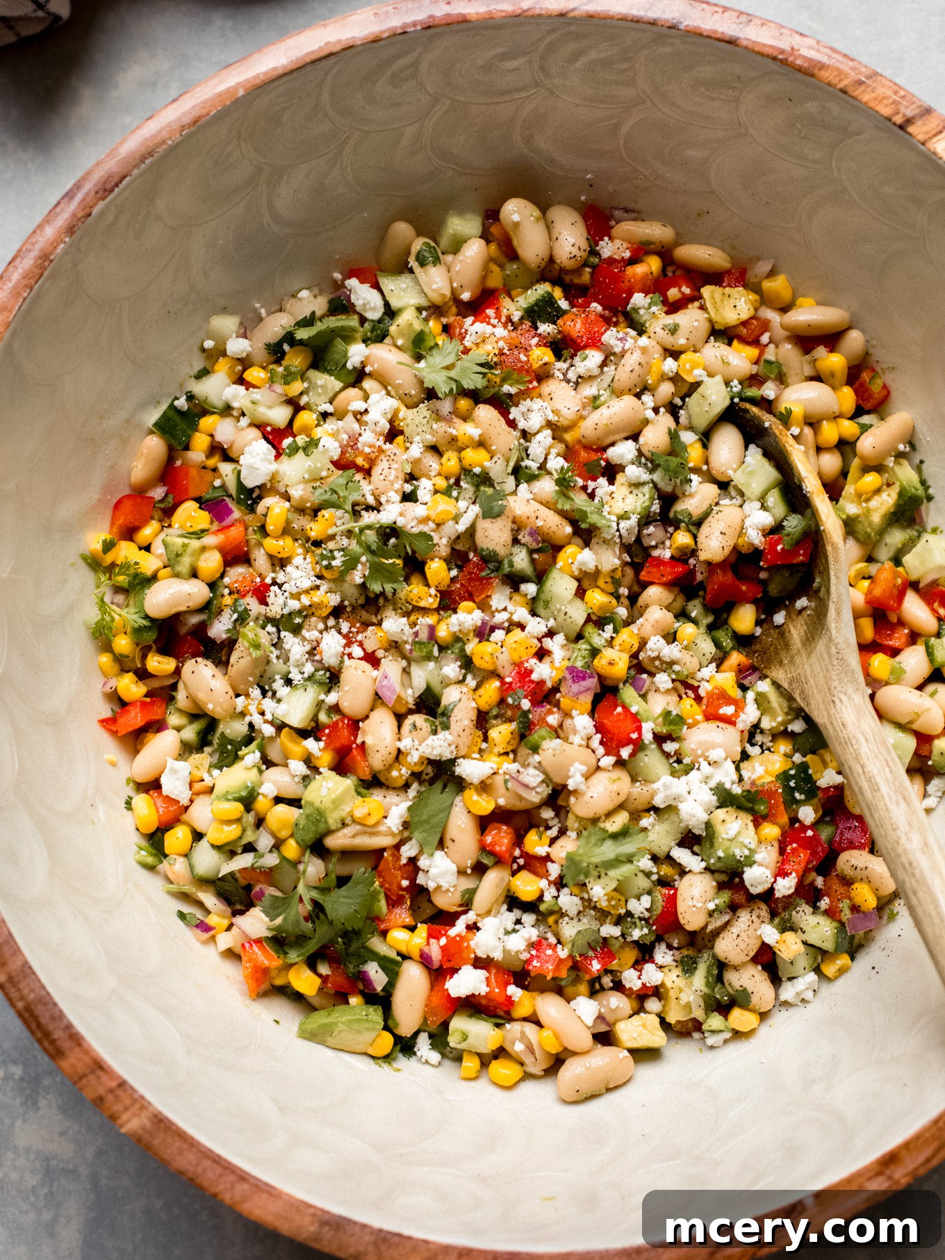 Close-up shot of the finished cannellini bean salad in a bowl, highlighting its fresh ingredients and vibrant colors.