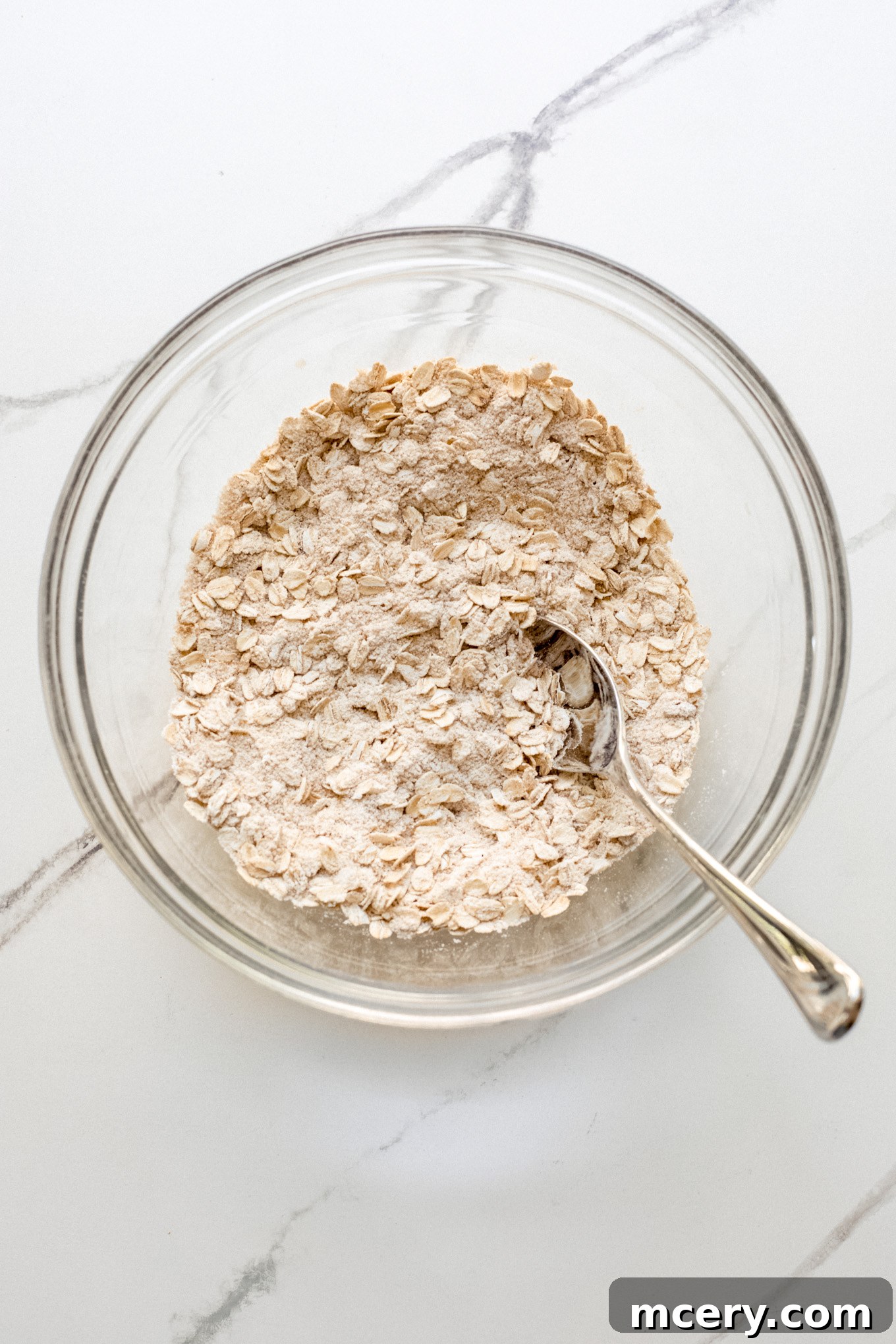 Golden Oat Topped Blueberry Crisp 6 Old-fashioned oats, flour, and brown sugar mixed in a glass bowl.