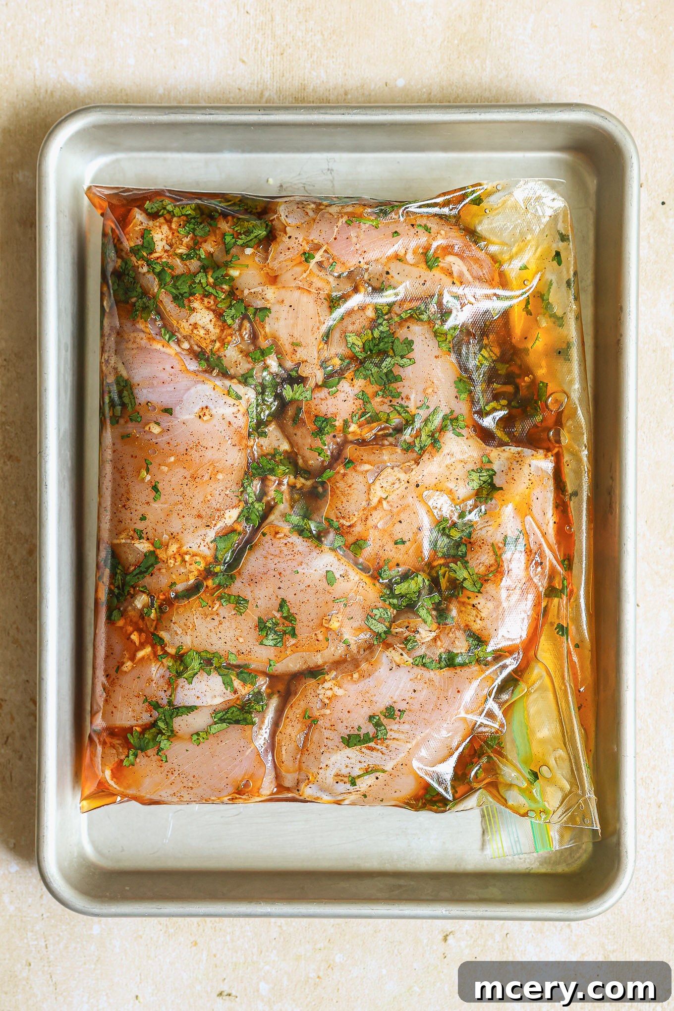 Vibrant Mexican Chicken Marinade 7 chicken inside ziploc bag laying on a baking sheet.