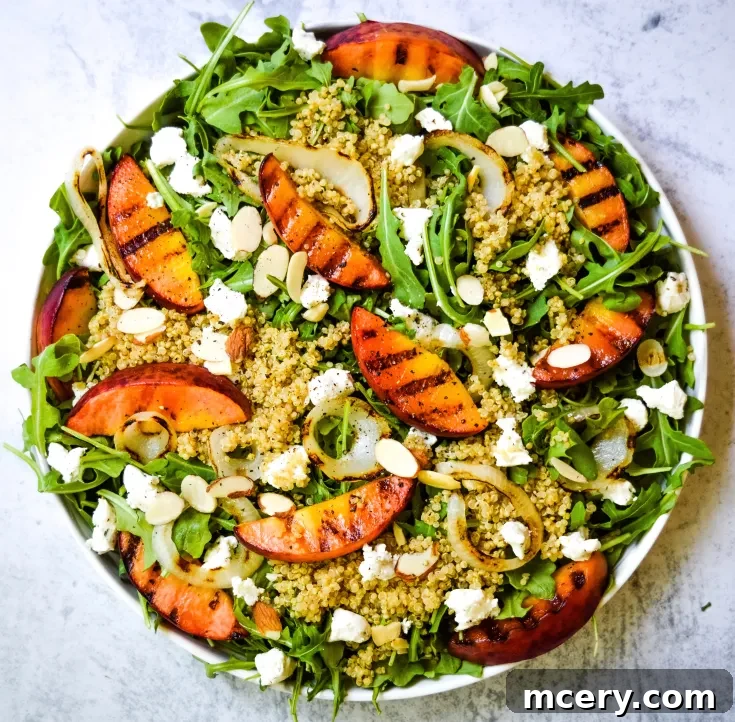 Grilled Peach & Goat Cheese Salad on a white plate with rustic decor.