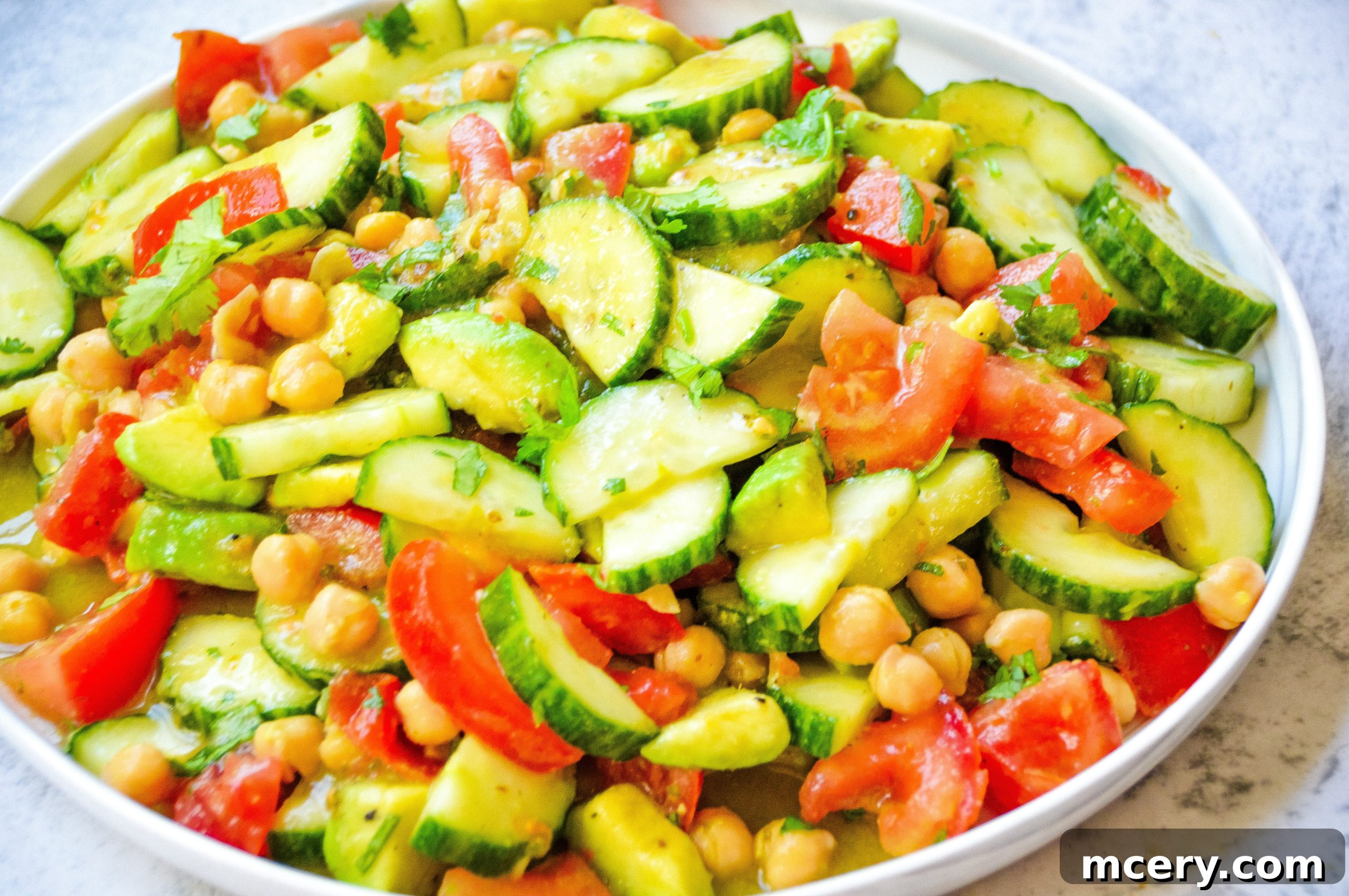 Refreshing Cucumber Avocado Salad with Tomatoes and Chickpeas 4 A close-up of the finished Healthy Cucumber Salad with Tomatoes, Avocado & Chickpeas, showcasing its vibrant colors and inviting texture.